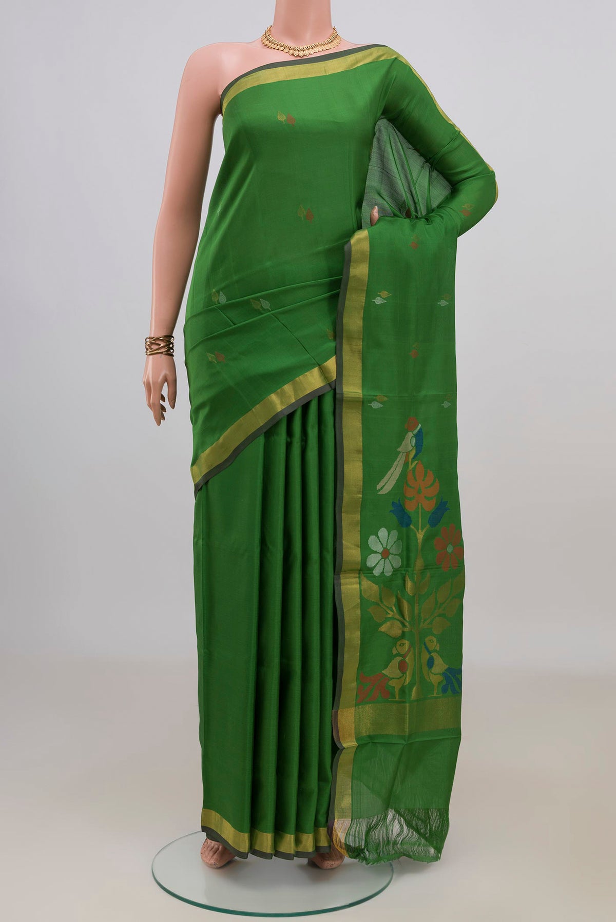 Pure Silk Green Uppada Saree with Thread Butta on the body and Zari Border.  displayed on a mannequin