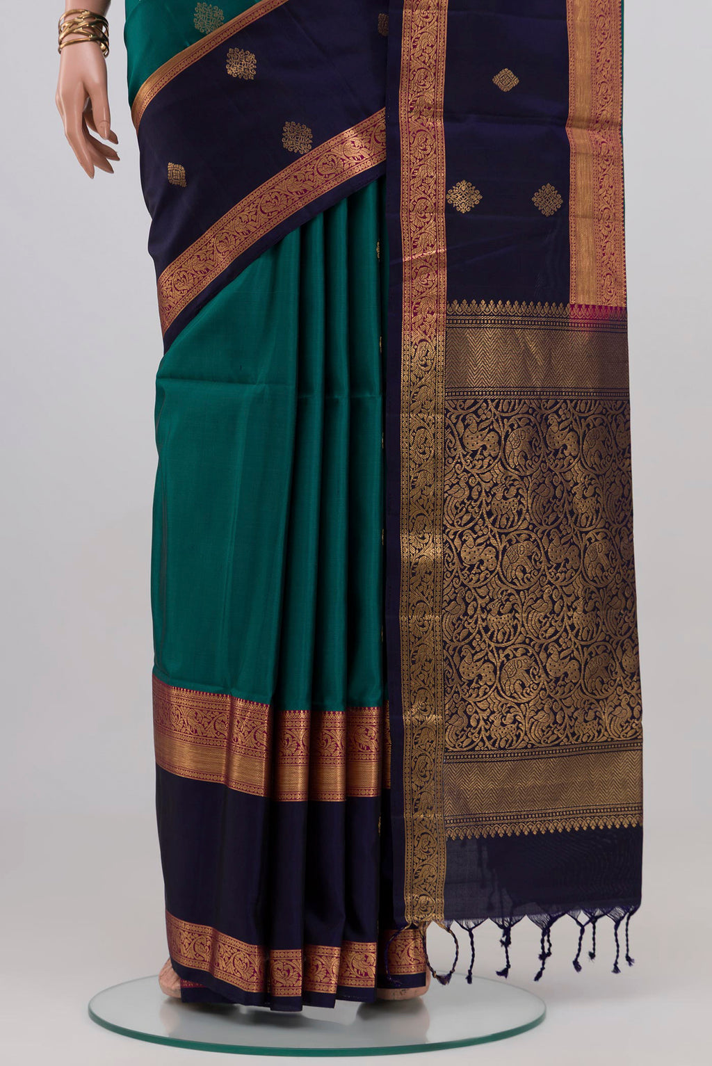 Pleats and pallu of Teal Soft Silk Saree with Zari Butta on the body and Fancy Border. 