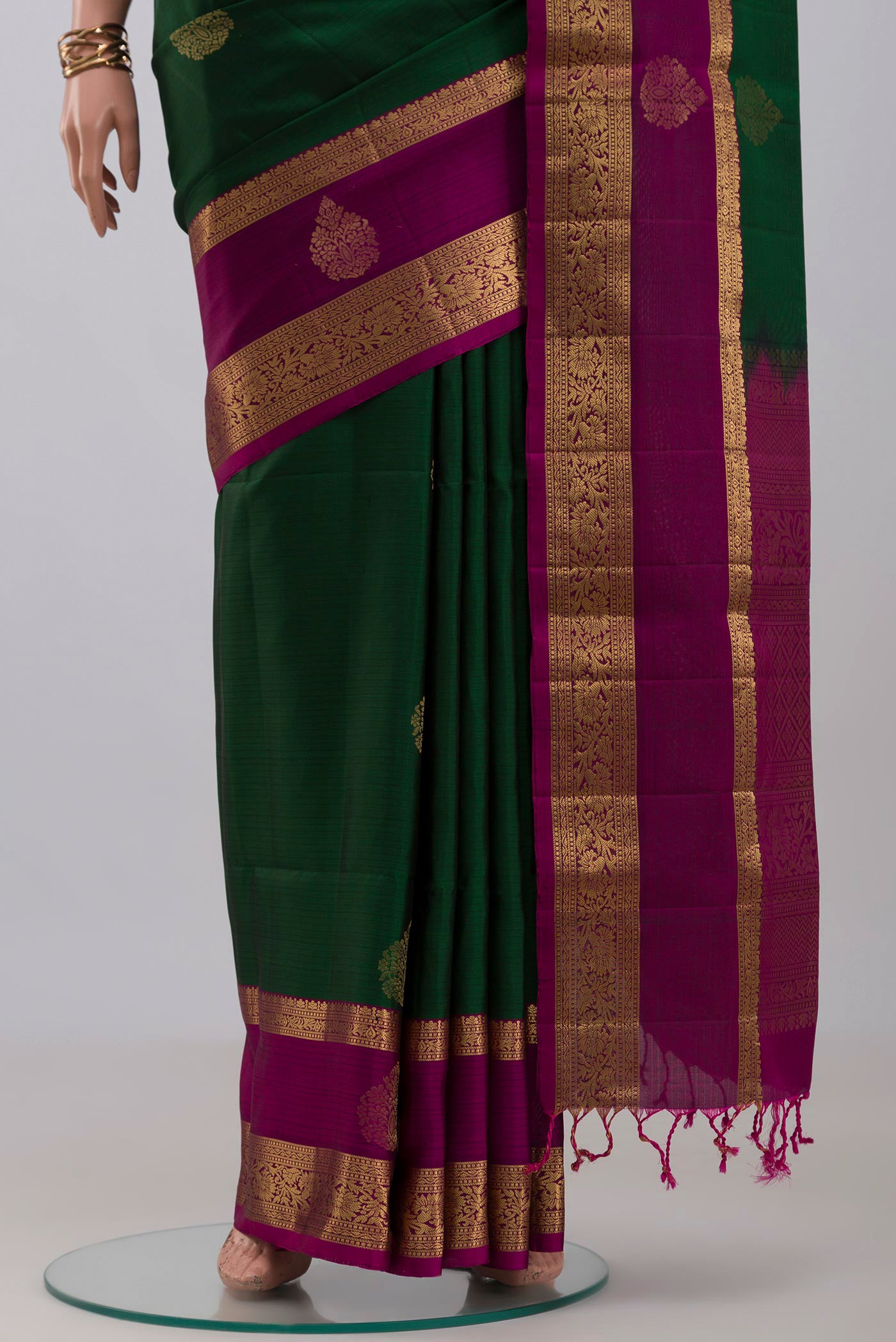 Pleats and pallu of Bottle Green Soft Silk Saree with Zari Butta on the body and Zari Border. 