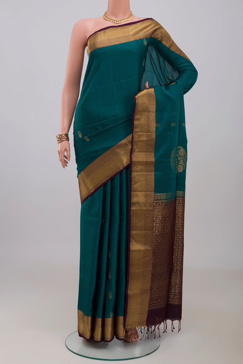 Peacock Blue Soft Silk Saree with Zari Butta on the body and Zari Border.  displayed on a mannequin