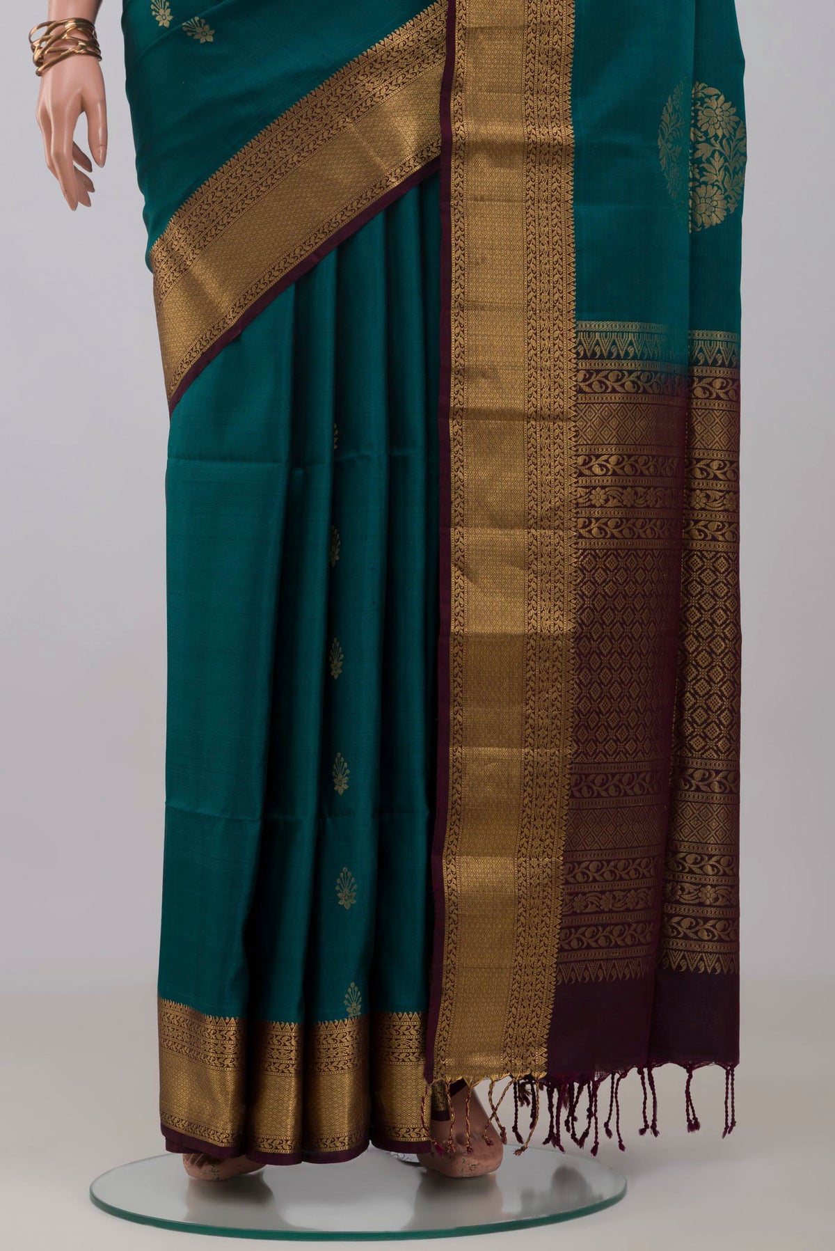 Pleats and pallu of Peacock Blue Soft Silk Saree with Zari Butta on the body and Zari Border. 