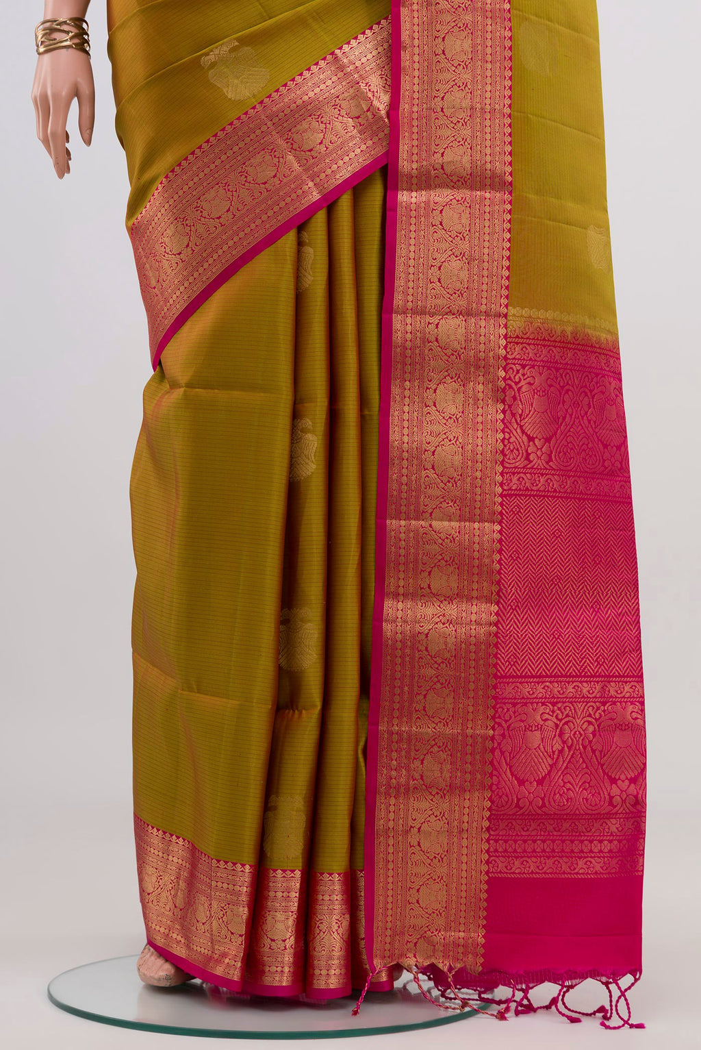 Pleats and pallu of Green Soft Silk Saree with Zari Butta on the body and Zari Border. 