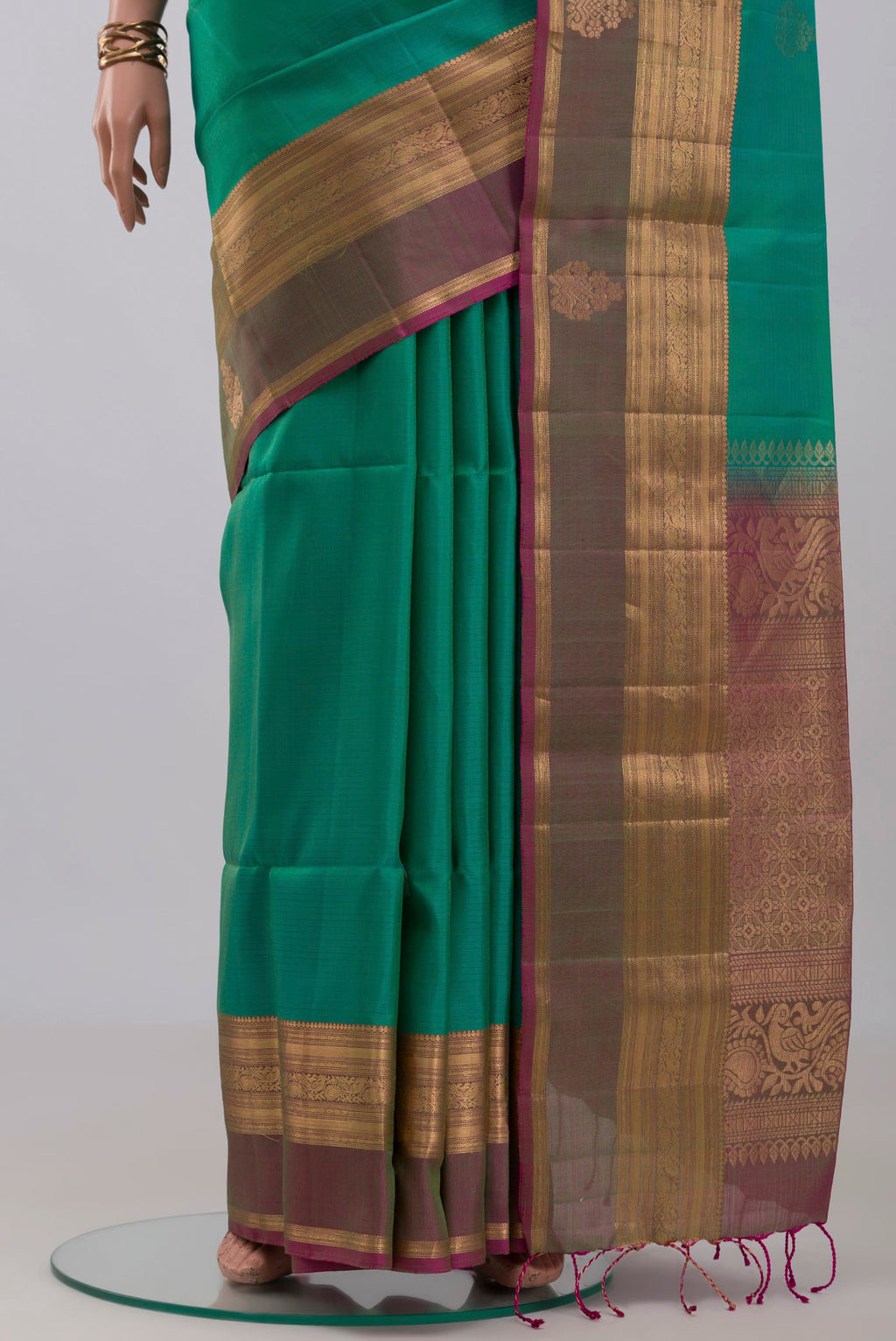Pleats and pallu of Turquoise Soft Silk Saree with Zari Butta on the body and Zari Border. 