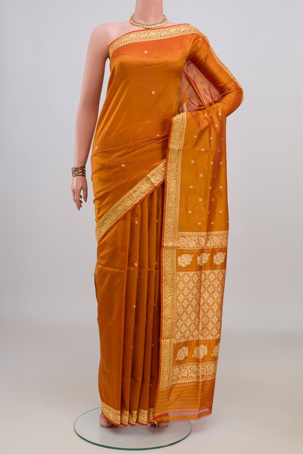 Pure Silk Mustard Banarasi Katan Saree with Thread Butta on the body and Thread Border.  displayed on a mannequin