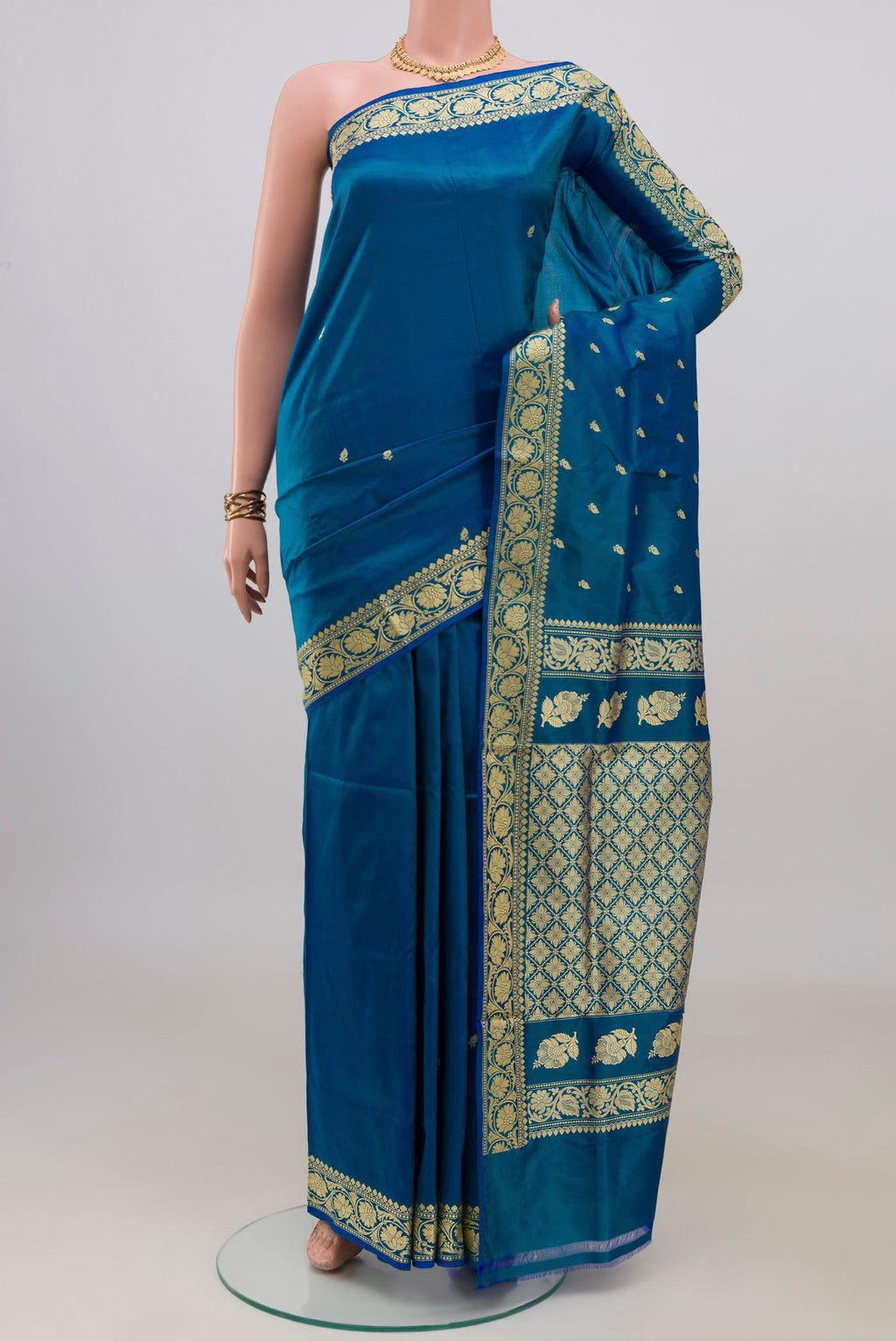 Pure Silk Blue Banarasi Katan Saree with Thread Butta on the body and Thread Border.  displayed on a mannequin