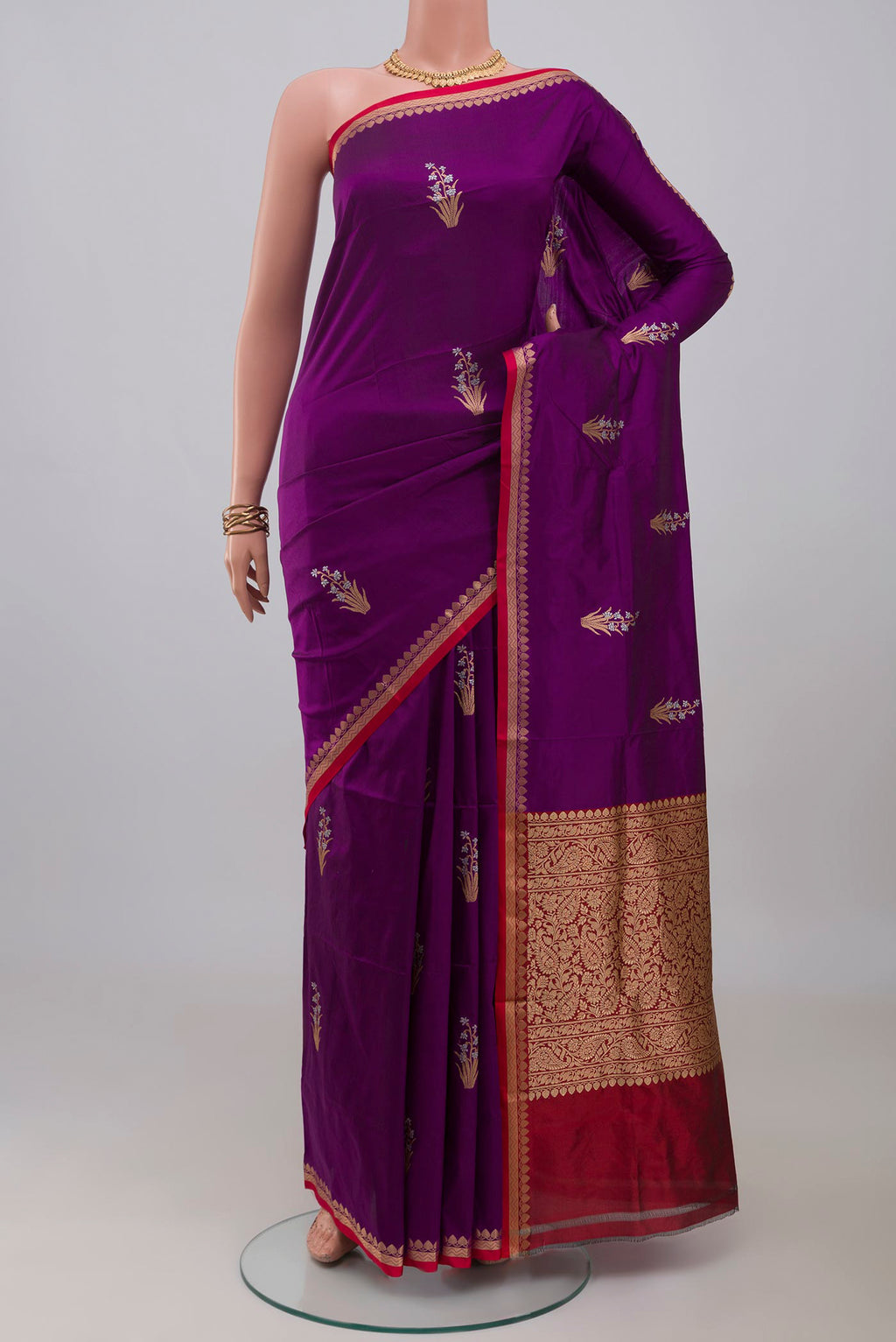Purple Banarasi Katan Silk Saree with Zari Butta on the body and Thin Zari Line.  displayed on a mannequin