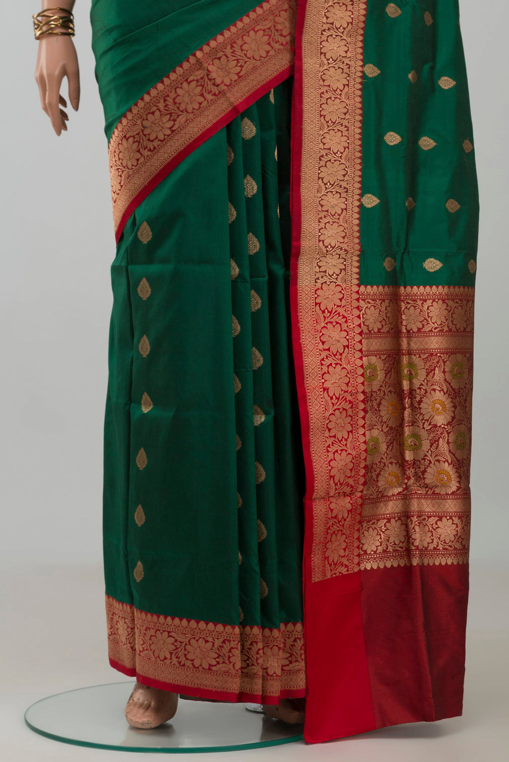 Pleats and pallu of Bottle Green Banarasi Katan Silk Saree with Zari Butta on the body and Fancy Border. 