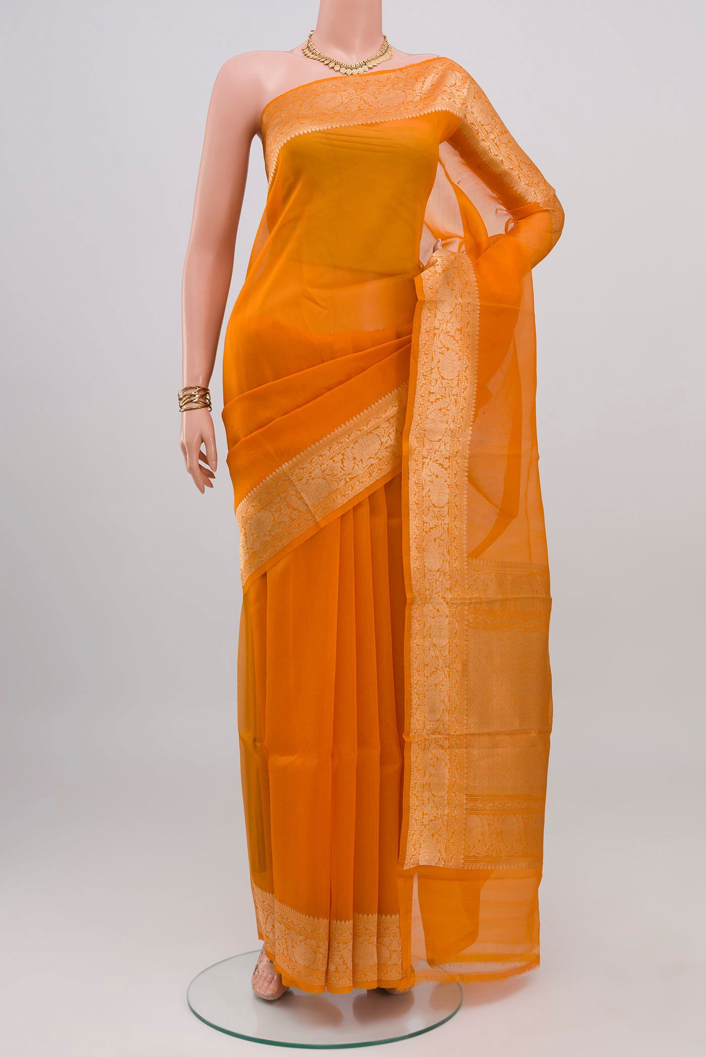 Orange Organza Silk Saree with Plain Body and Zari Border.  displayed on a mannequin