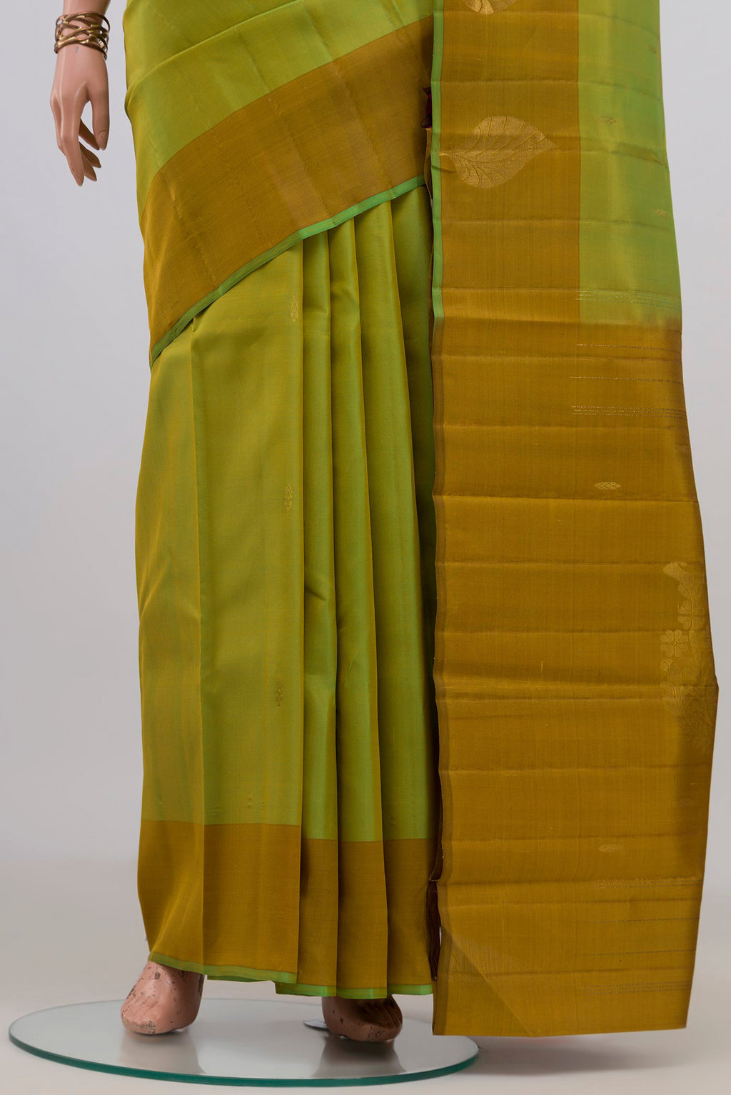 Pleats and pallu of Pure Silk Green Kanchipuram Saree with Zari Butta on the body and Fancy Border. 