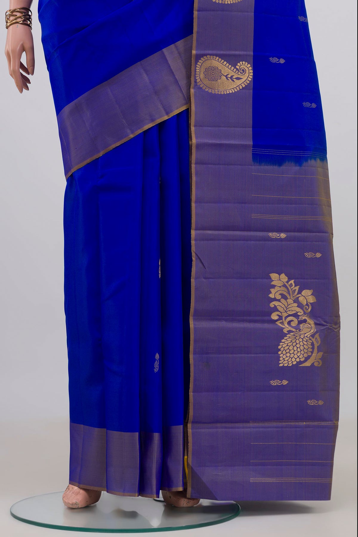 Pleats and pallu of Pure Silk Royal Blue Kanchipuram Saree with Zari Butta on the body and Fancy Border. 