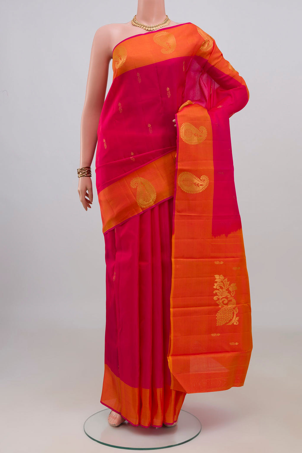 Pure Silk Pink Kanchipuram Saree with Zari Butta on the body and Fancy Border.  displayed on a mannequin