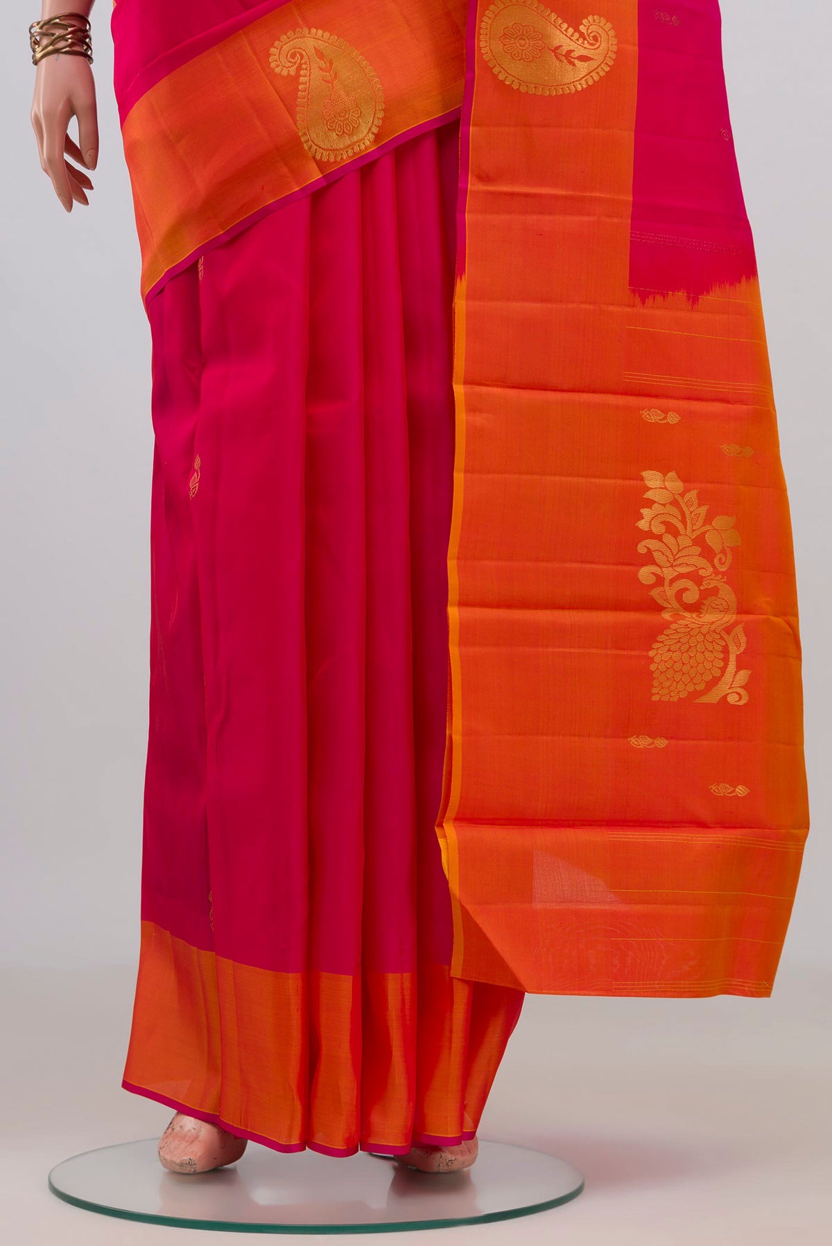 Pleats and pallu of Pure Silk Pink Kanchipuram Saree with Zari Butta on the body and Fancy Border. 