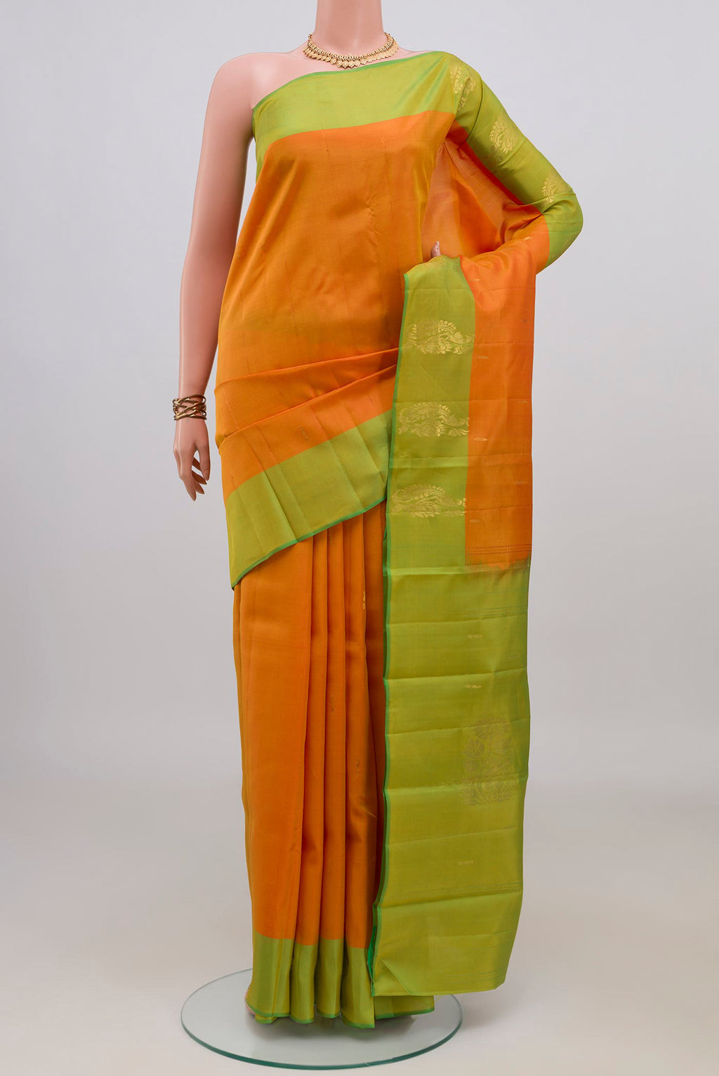 Pure Silk Yellow Kanchipuram Saree with Zari Butta on the body and Fancy Border.  displayed on a mannequin