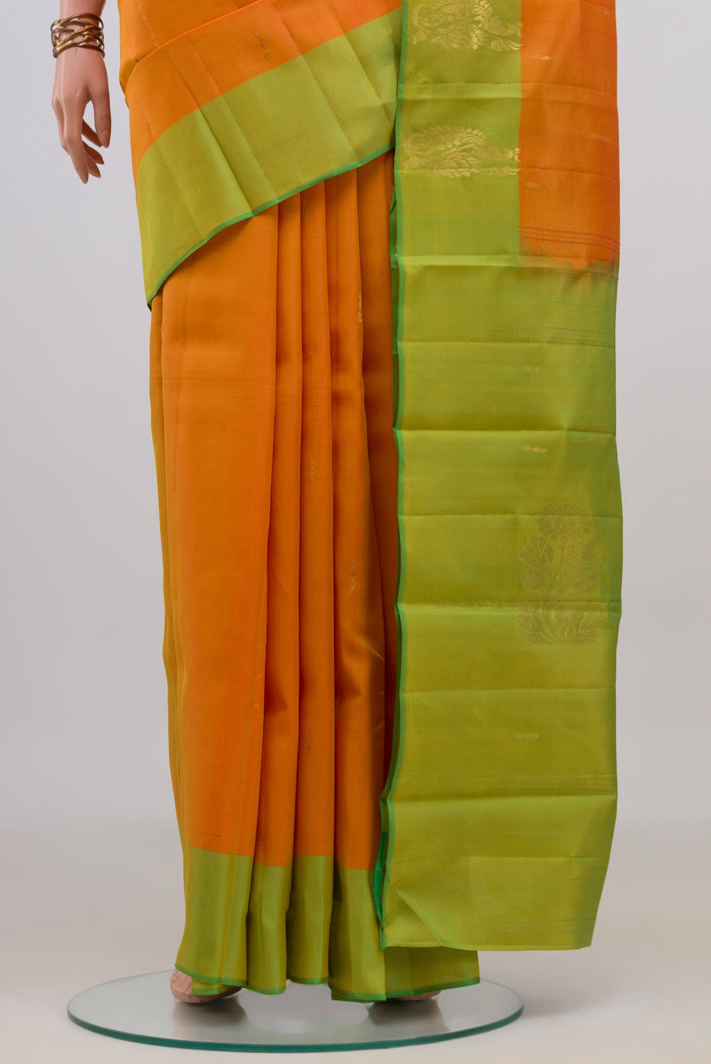 Pleats and pallu of Pure Silk Yellow Kanchipuram Saree with Zari Butta on the body and Fancy Border. 