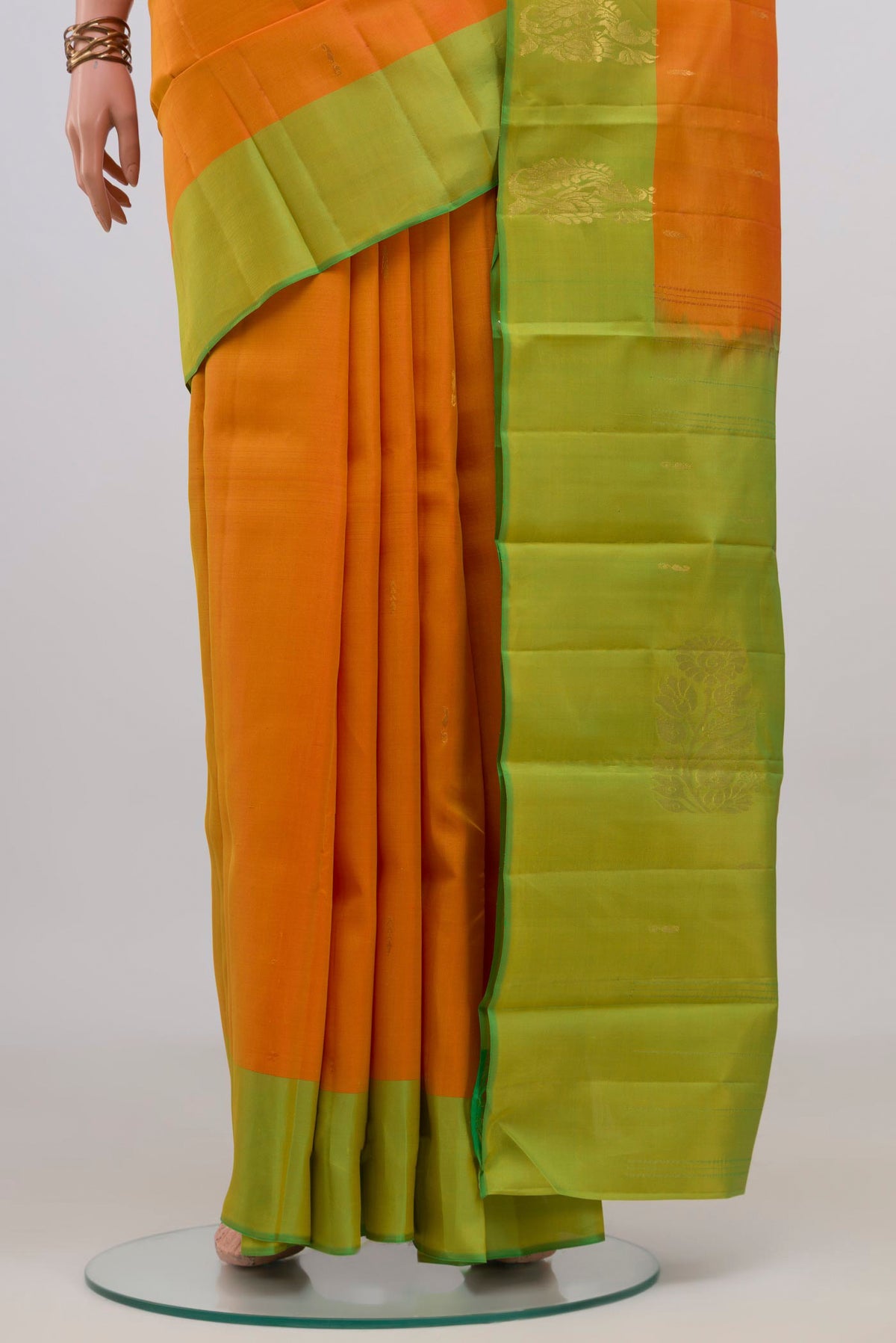 Pleats and pallu of Pure Silk Yellow Kanchipuram Saree with Zari Butta on the body and Fancy Border. 