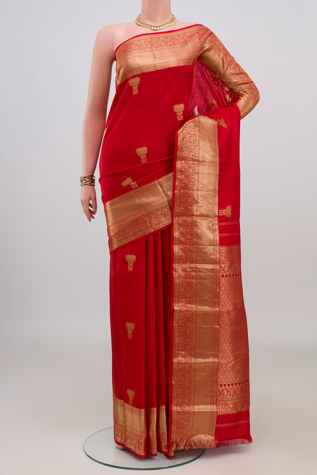 Pure Silk Red Kanchipuram Saree with Zari Butta on the body and Zari Border.  displayed on a mannequin