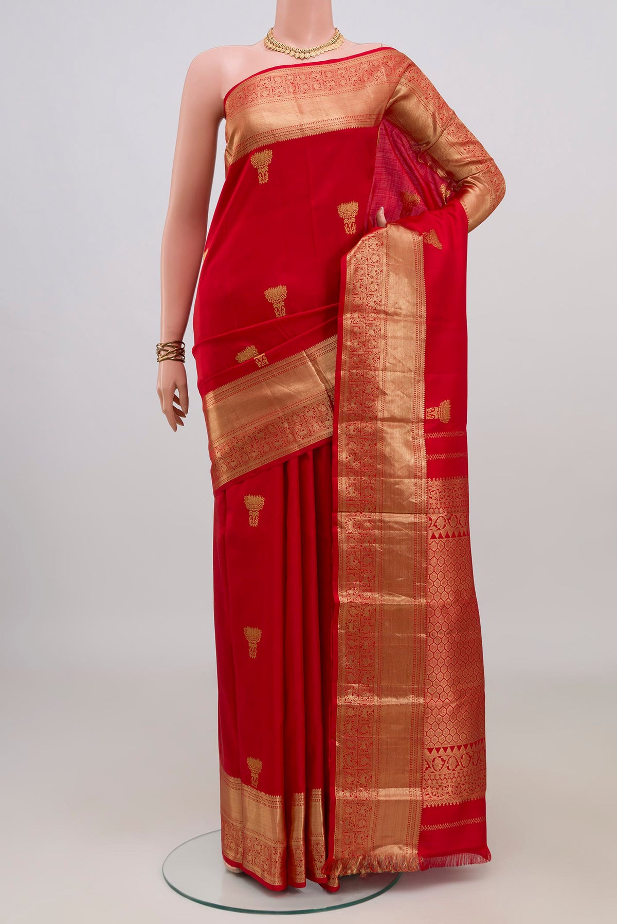 Pure Silk Red Kanchipuram Saree with Zari Butta on the body and Zari Border.  displayed on a mannequin