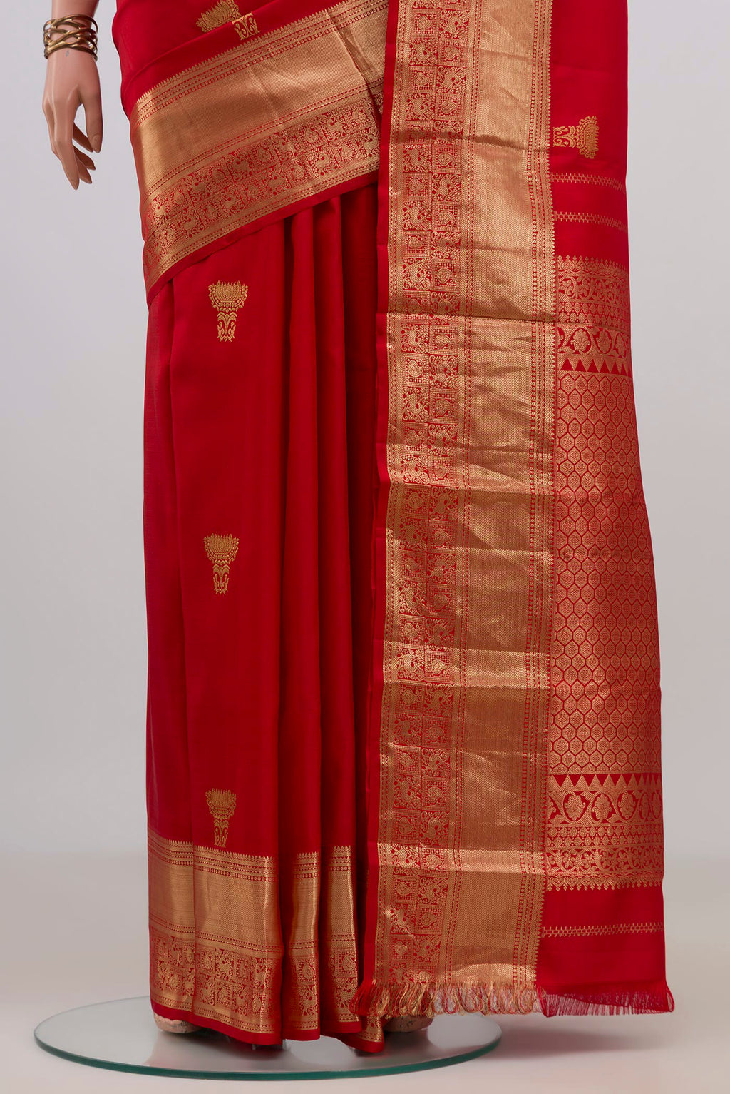 Pleats and pallu of Pure Silk Red Kanchipuram Saree with Zari Butta on the body and Zari Border. 