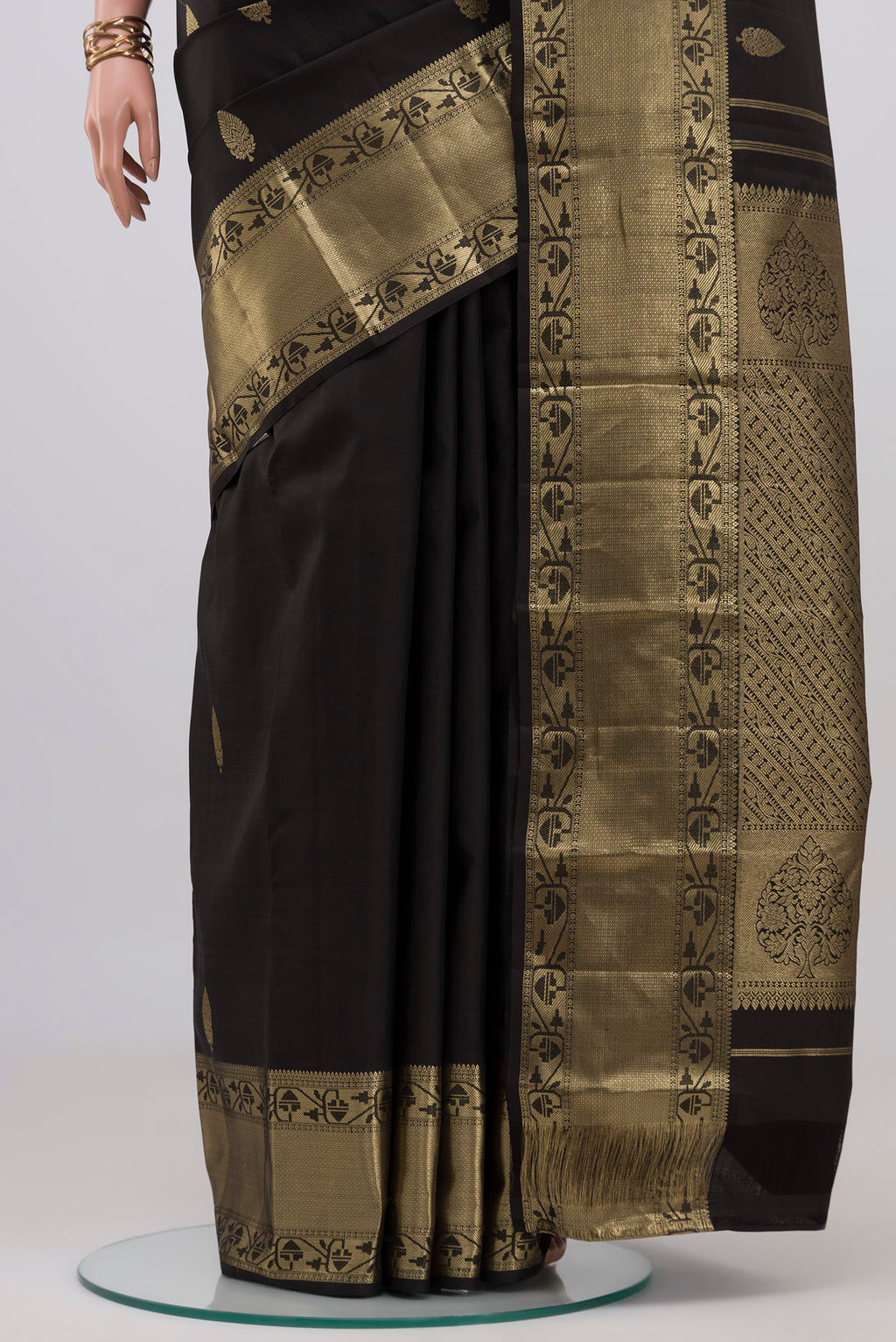 Pleats and pallu of Black Kanchipuram Silk Saree with Zari Butta on the body and Zari Border. 
