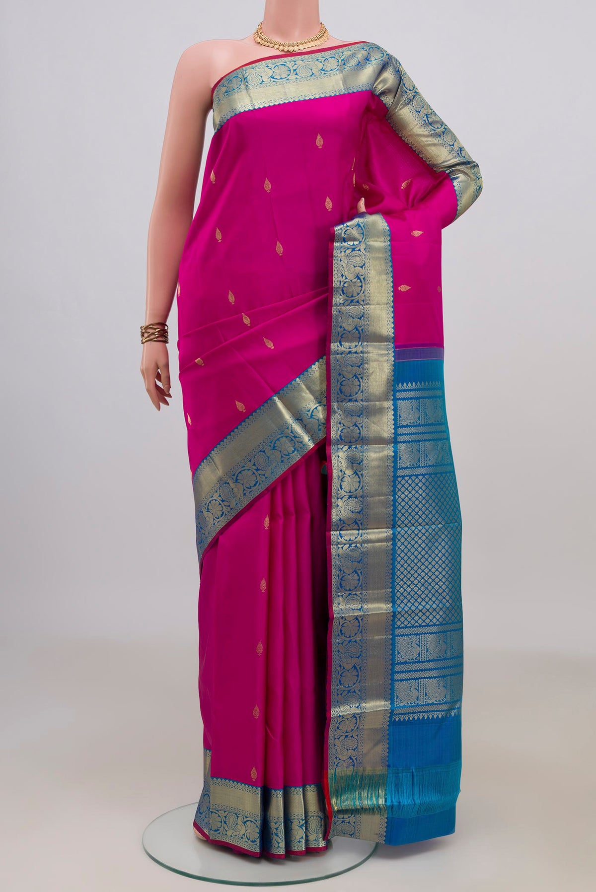 Pure Silk Pink Kanjivaram Saree with Zari Butta on the body and Zari Border.  displayed on a mannequin