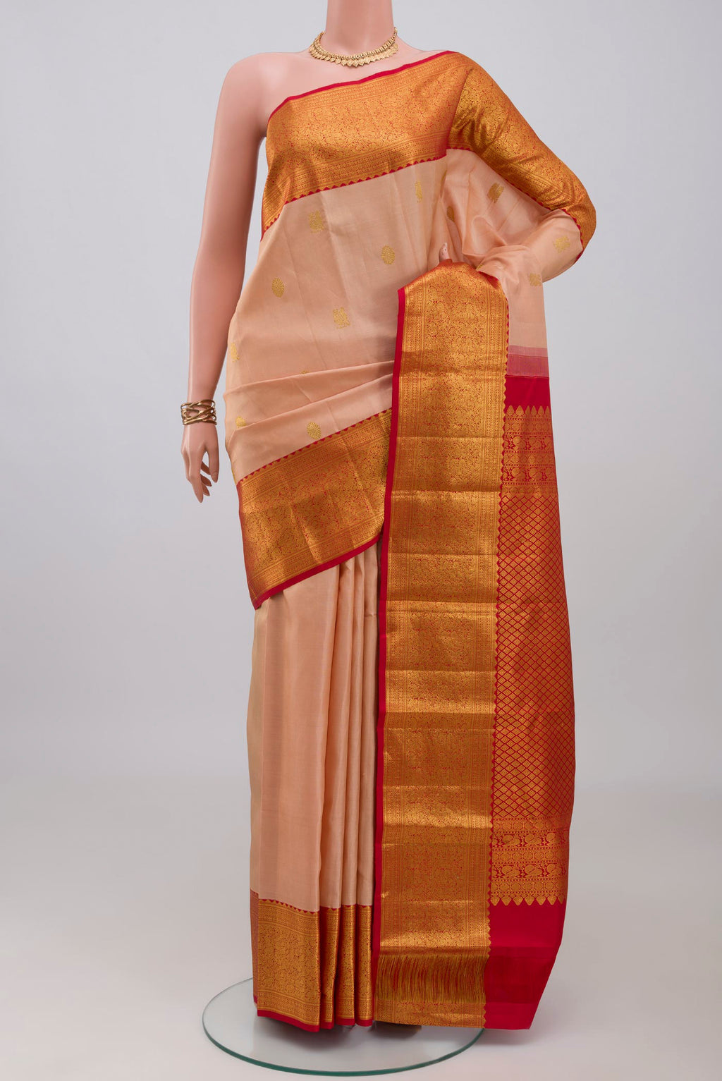 Rose Gold Kanjivaram Silk Saree with Zari Butta on the body and Zari Border.  displayed on a mannequin
