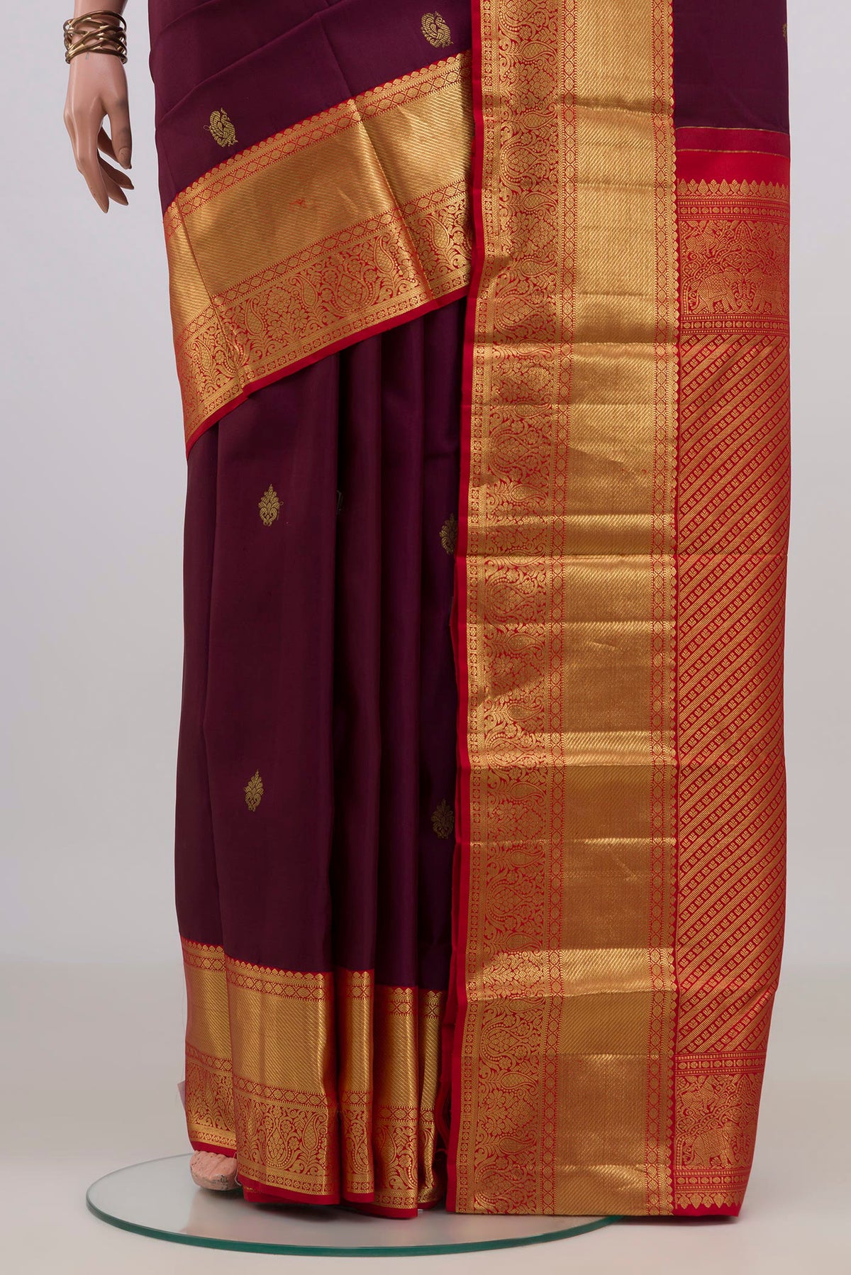 Pleats and pallu of Pure Silk Purple Kanjivaram Saree with Zari Butta on the body and Zari Border. 