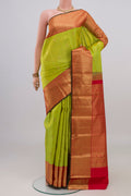 Parrot Green Kanjivaram Silk Saree with Zari Butta on the body and Zari Border.  displayed on a mannequin