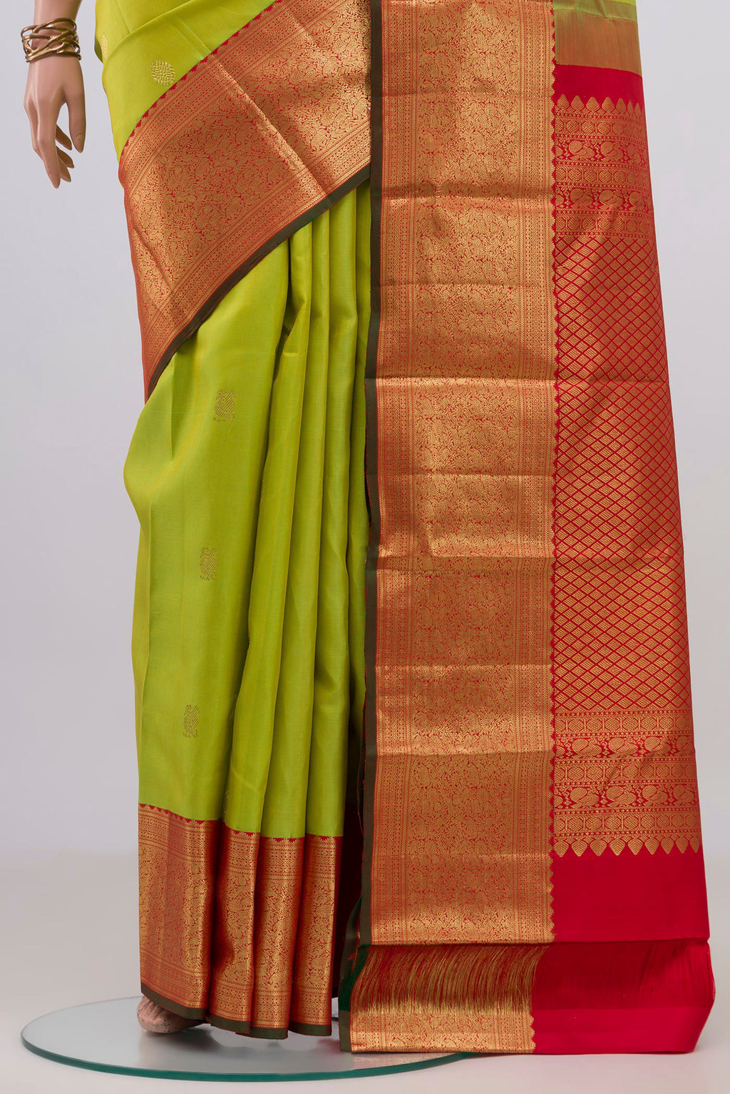 Pleats and pallu of Parrot Green Kanjivaram Silk Saree with Zari Butta on the body and Zari Border. 