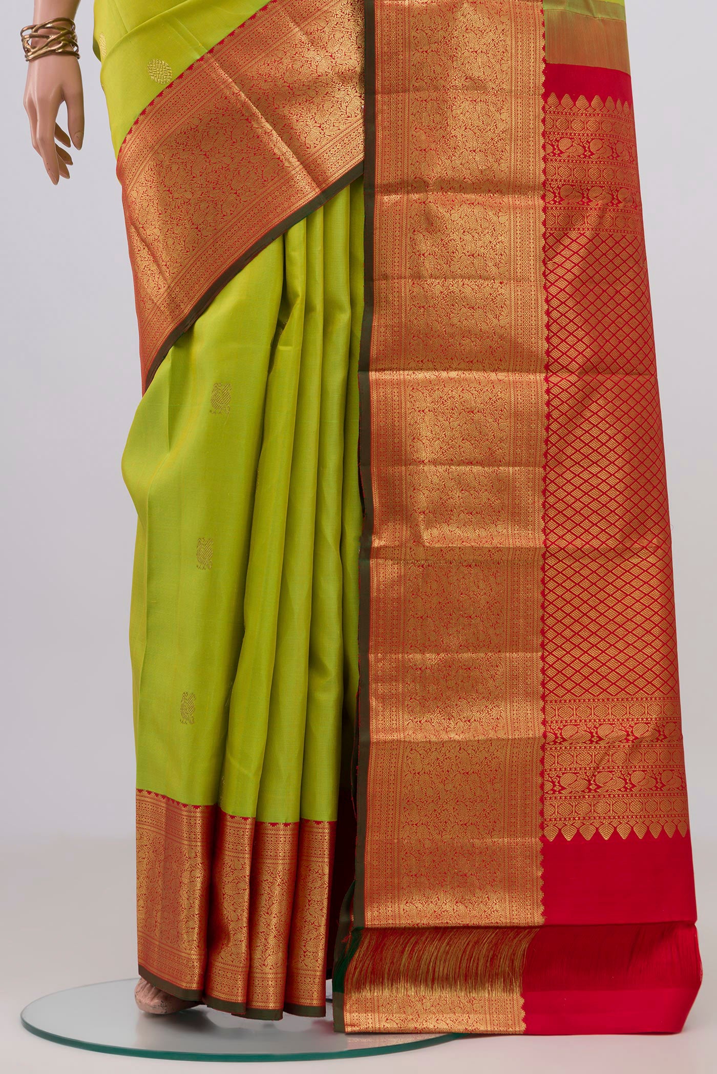 Pleats and pallu of Parrot Green Kanjivaram Silk Saree with Zari Butta on the body and Zari Border. 
