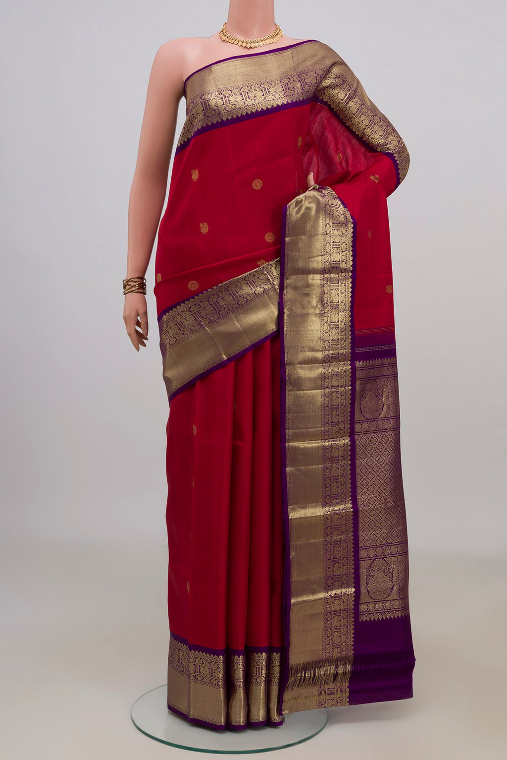 Pure Silk Red Kanjivaram Saree with Zari Butta on the body and Zari Border.  displayed on a mannequin