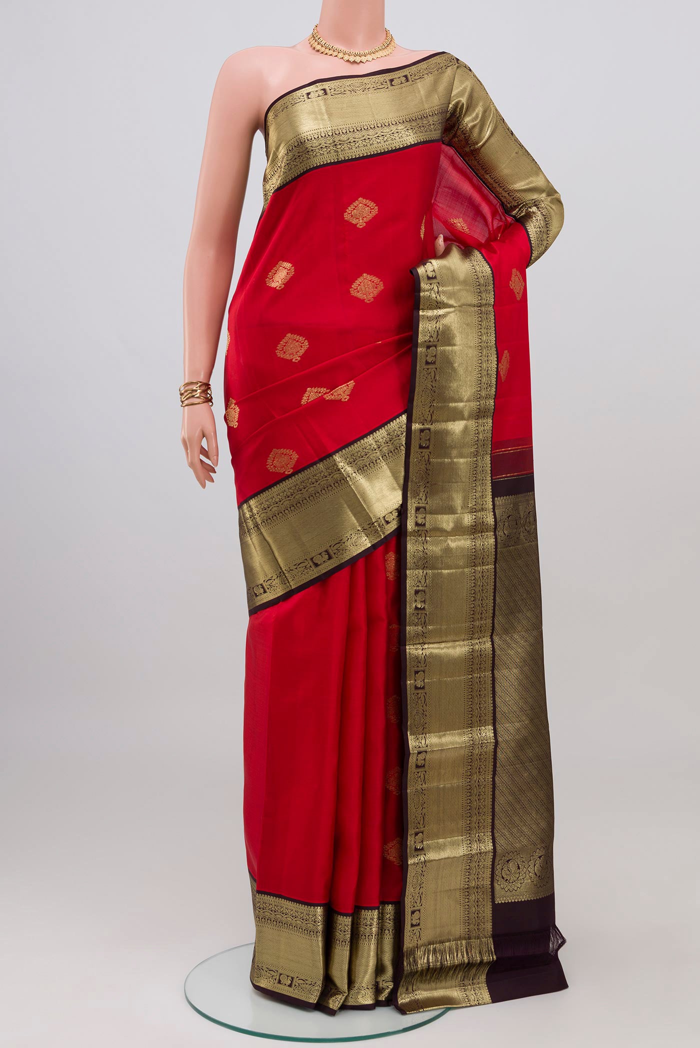 Red Kanjivaram Silk Saree with Zari Butta on the body and Zari Border.  displayed on a mannequin