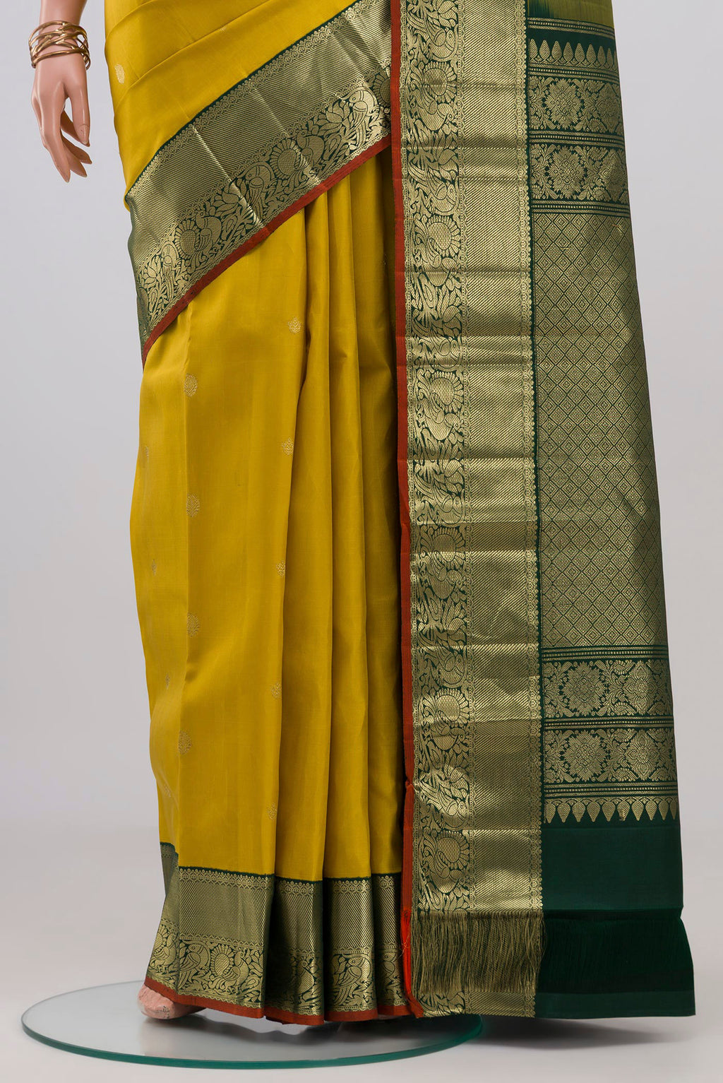 Pleats and pallu of Yellow Kanjivaram Silk Saree with Zari Butta on the body and Zari Border. 
