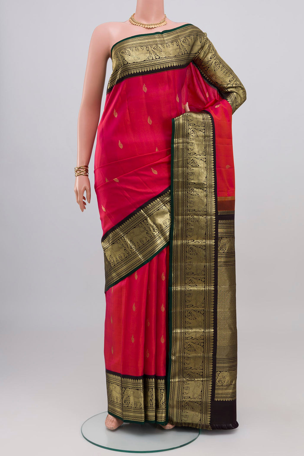 Pink Kanjivaram Silk Saree with Zari Butta on the body and Zari Border.  displayed on a mannequin