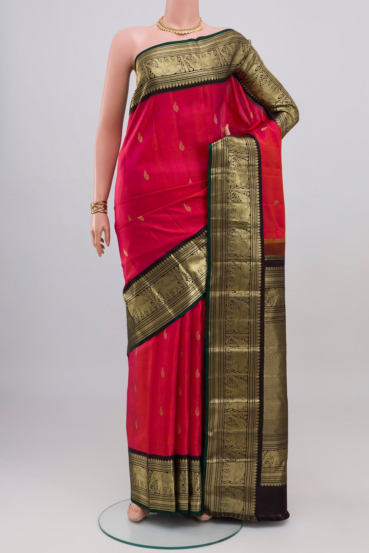Pink Kanjivaram Silk Saree with Zari Butta on the body and Zari Border.  displayed on a mannequin