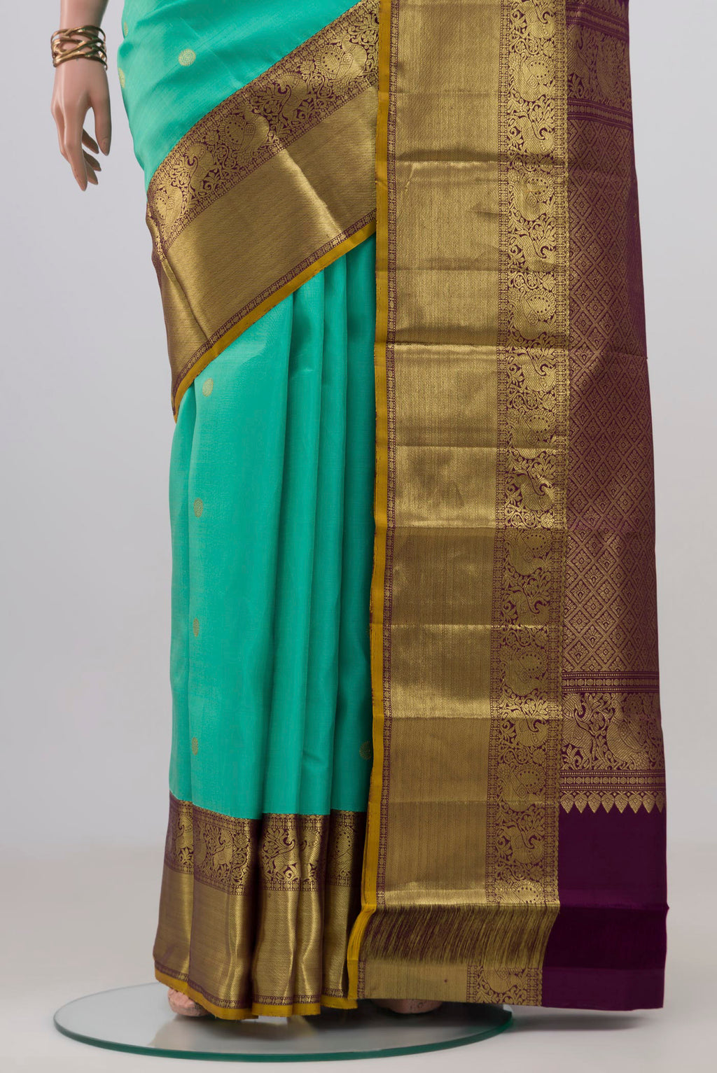 Pleats and pallu of Turquoise Kanjivaram Silk Saree with Zari Butta on the body and Zari Border. 