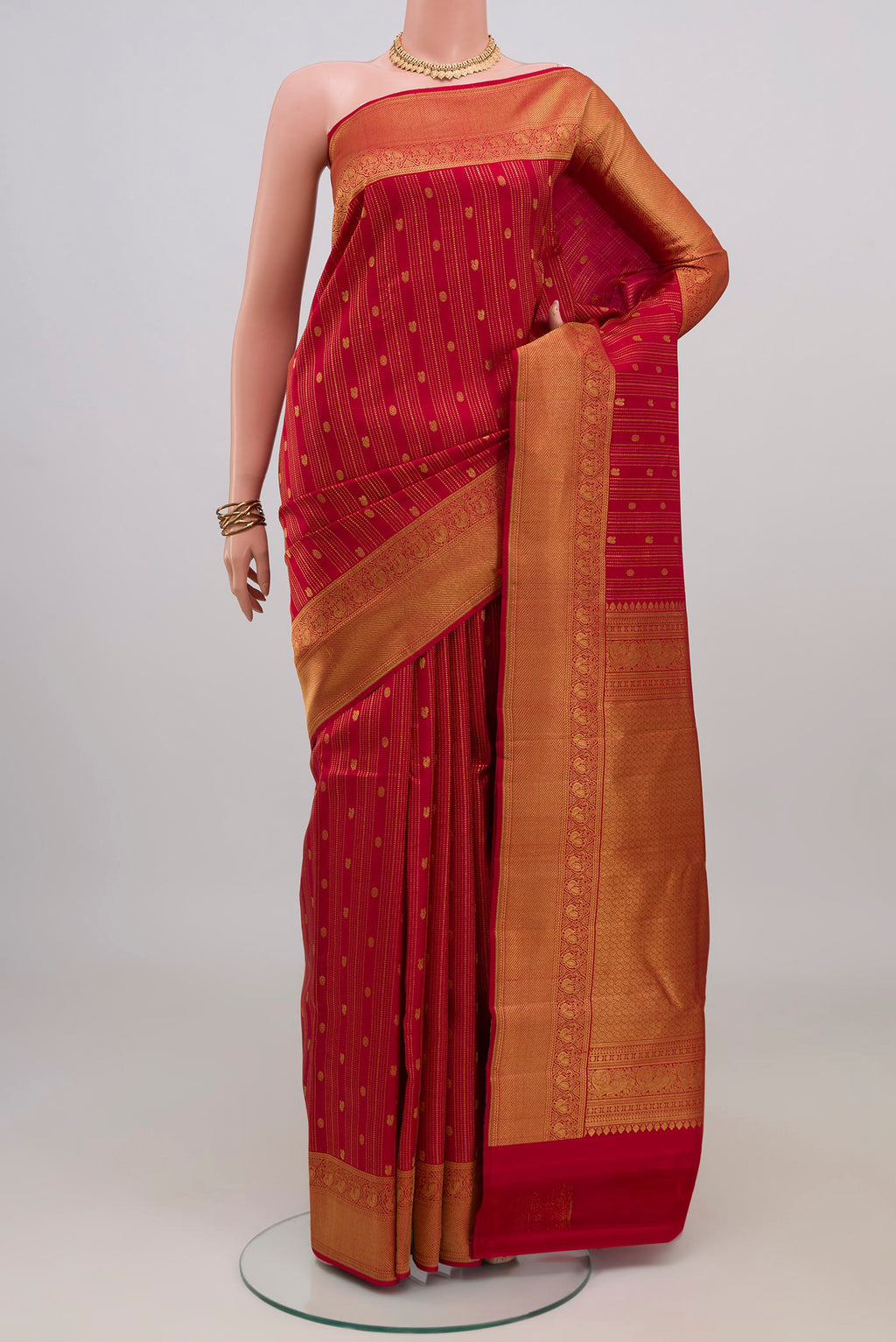 Red Kanjivaram Silk Saree with Stripes on the body and Zari Border.  displayed on a mannequin