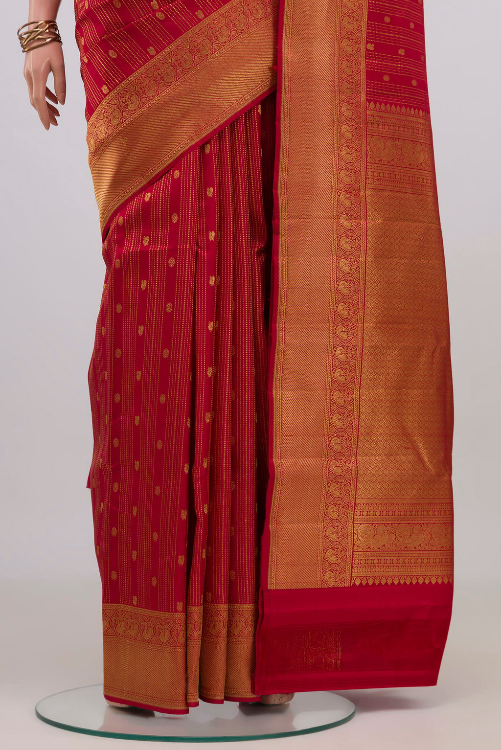 Pleats and pallu of Red Kanjivaram Silk Saree with Stripes on the body and Zari Border. 