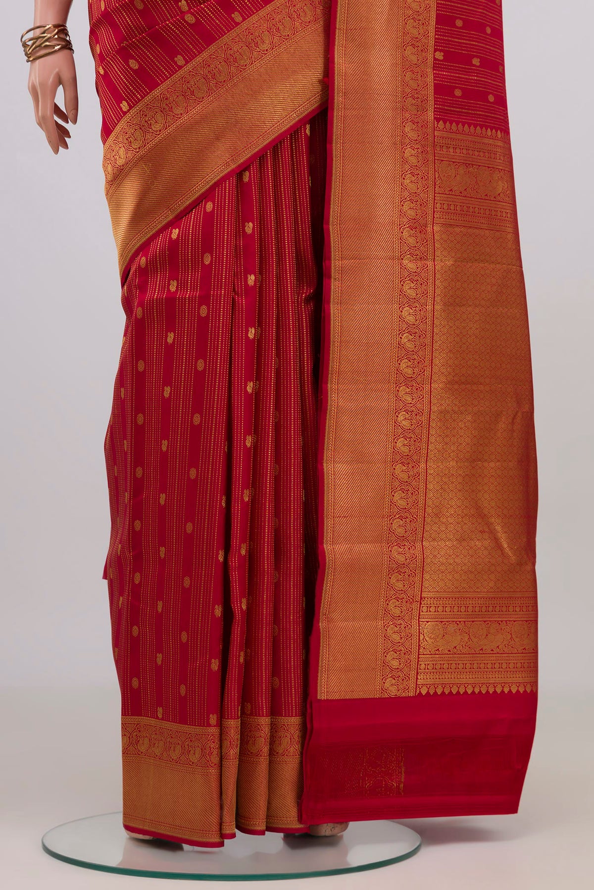 Pleats and pallu of Red Kanjivaram Silk Saree with Stripes on the body and Zari Border. 