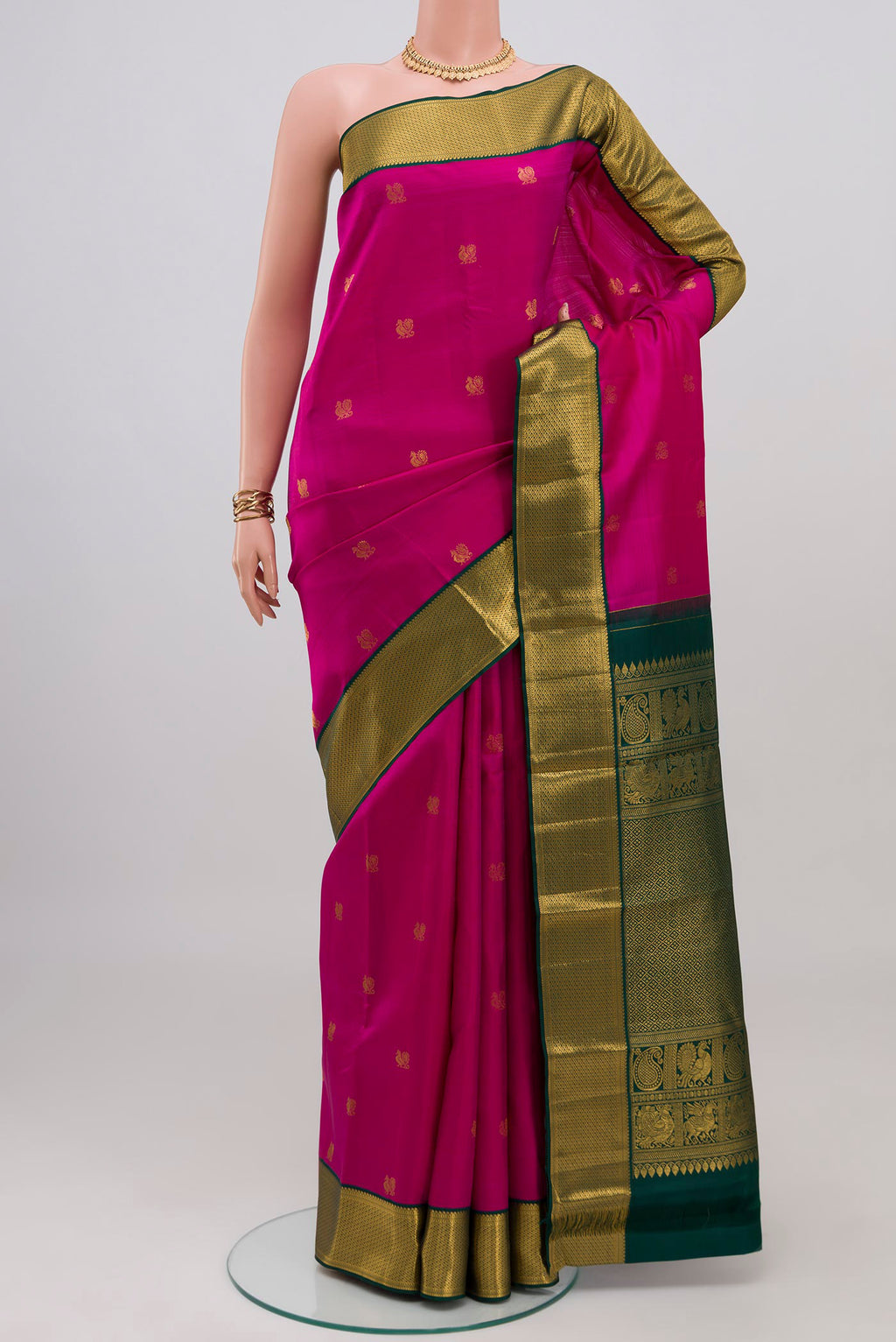 Pink Kanjivaram Silk Saree with Zari Butta on the body and Zari Border.  displayed on a mannequin