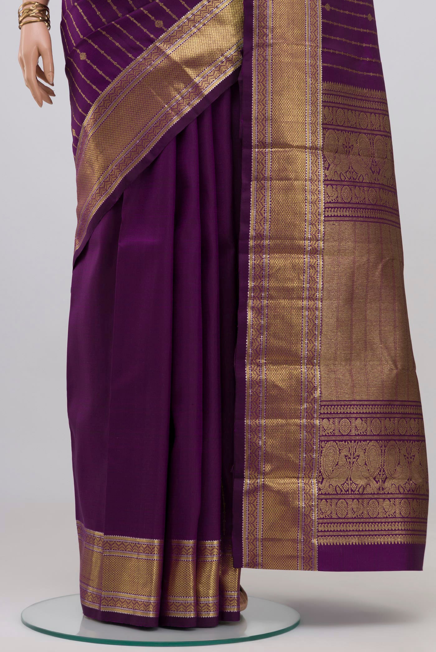 Pleats and pallu of Purple Kanchipuram Silk Saree with Stripes on the body and Zari Border. 