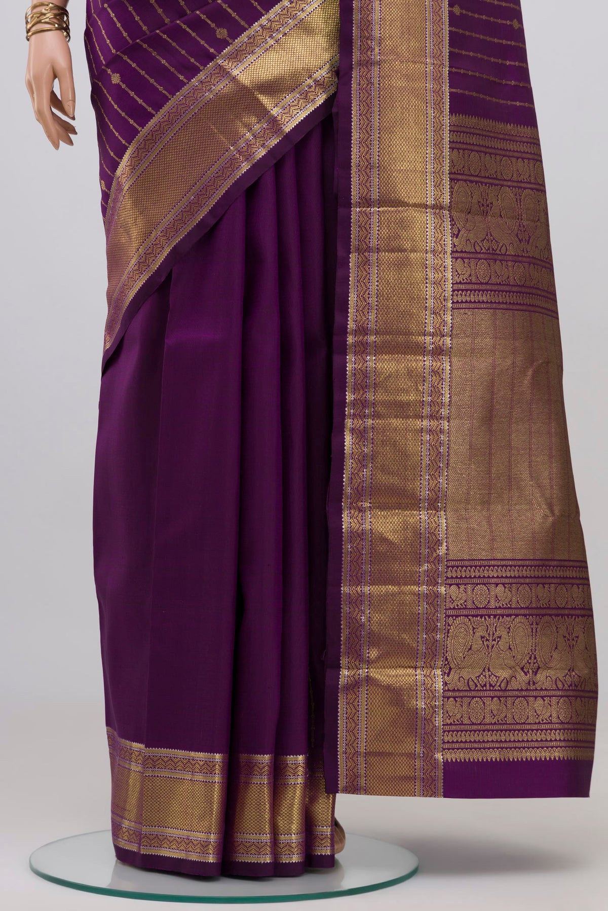 Pleats and pallu of Purple Kanchipuram Silk Saree with Stripes on the body and Zari Border. 