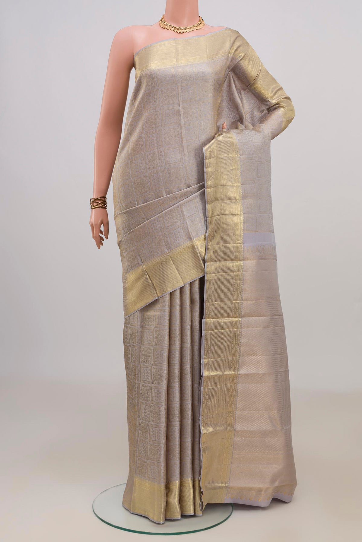 Pure Silk Grey Kanchipuram Saree with Zari Brocade on the body and Zari Border.  displayed on a mannequin