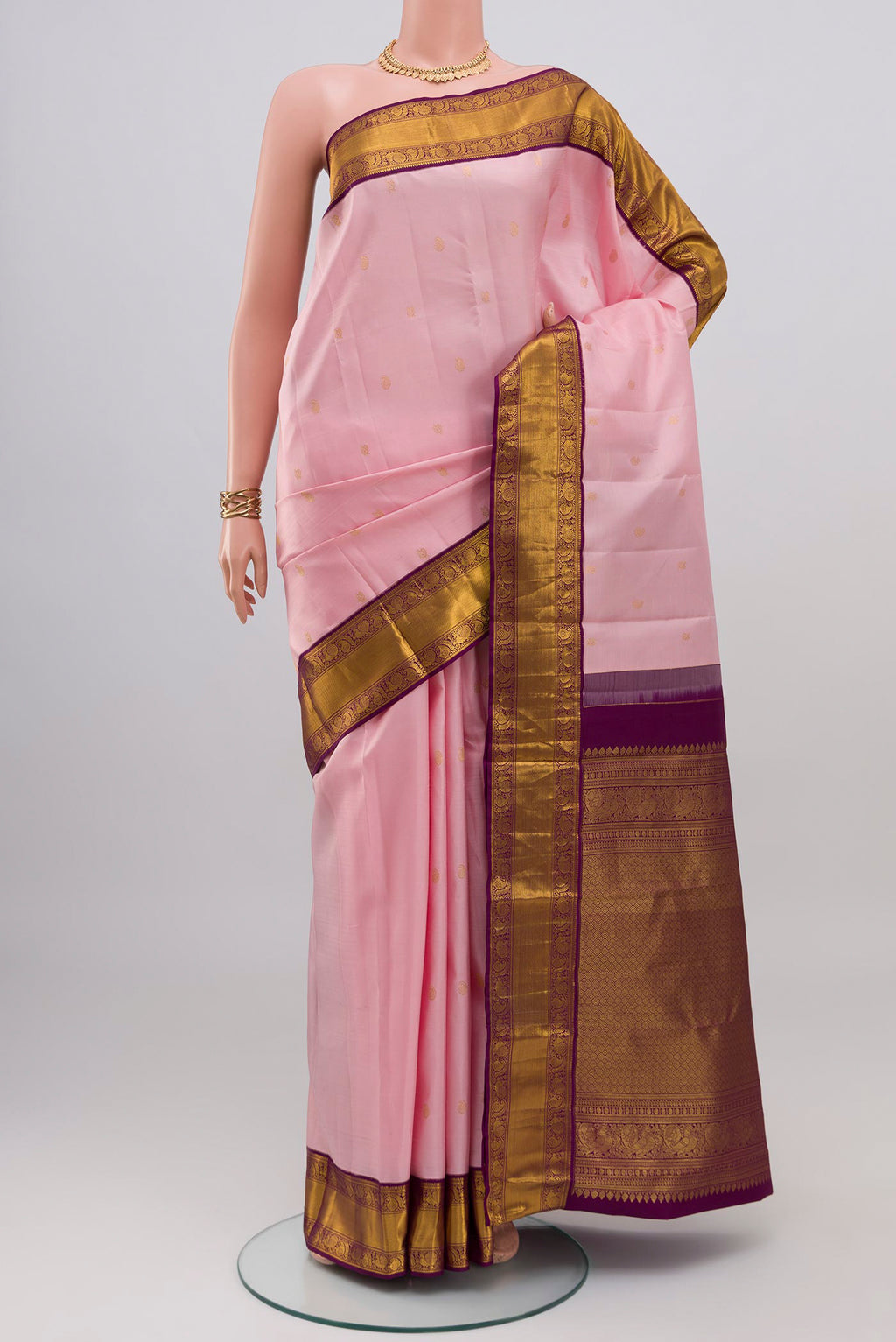 Rose pink Kanjivaram Silk Saree with Zari Butta on the body and Zari Border.  displayed on a mannequin