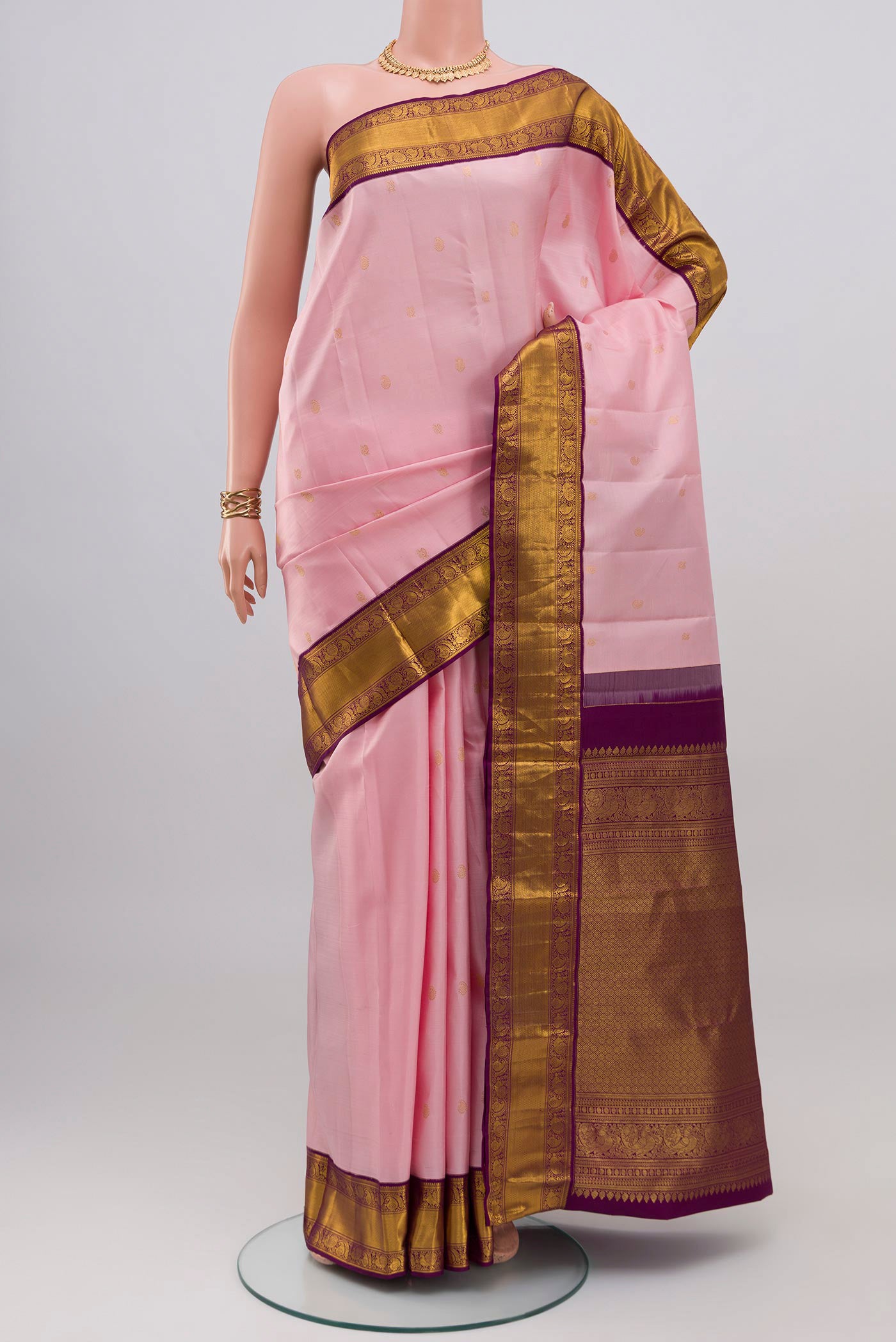 Rose pink Kanjivaram Silk Saree with Zari Butta on the body and Zari Border.  displayed on a mannequin