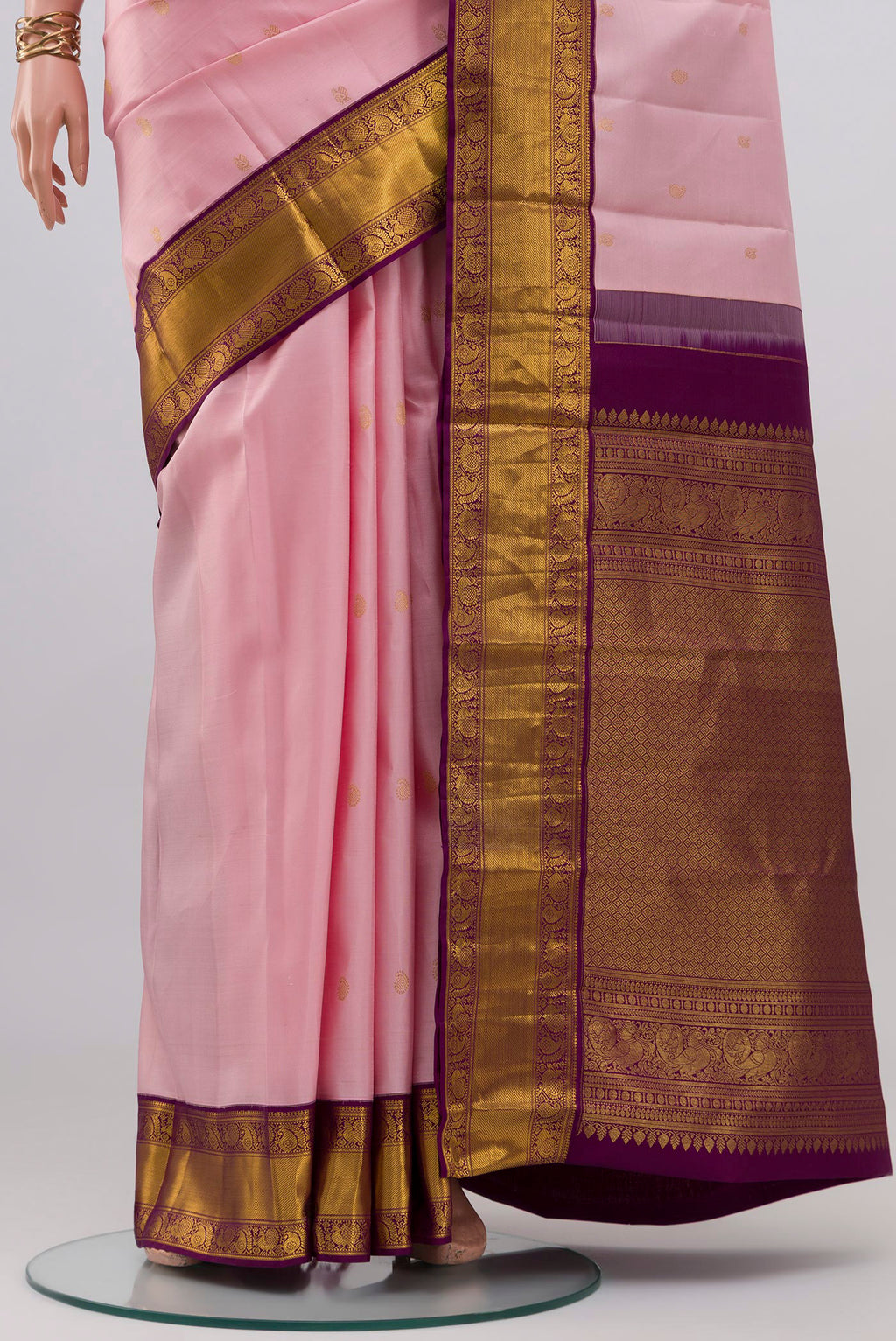 Pleats and pallu of Rose pink Kanjivaram Silk Saree with Zari Butta on the body and Zari Border. 
