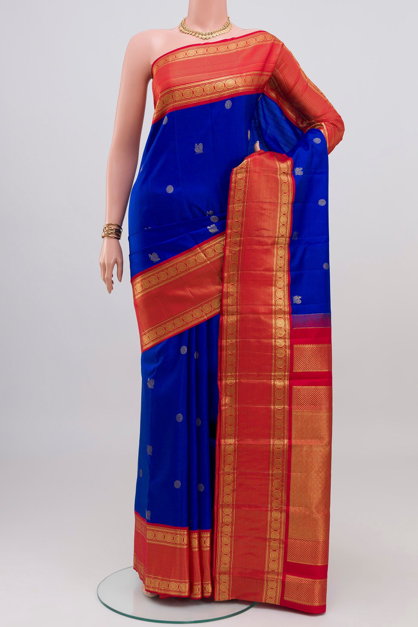 Royal Blue Kanjivaram Silk Saree with Zari Butta on the body and Zari Border.  displayed on a mannequin