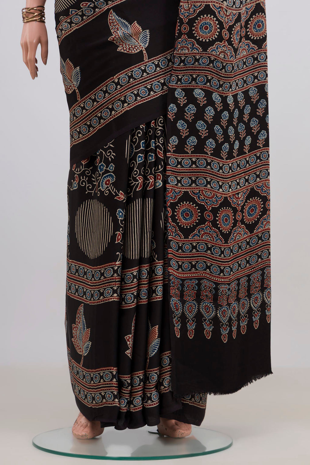 Pleats and pallu of Black Blended Satin Silk Saree with Ajrakh Print on the body and Printed Border. 