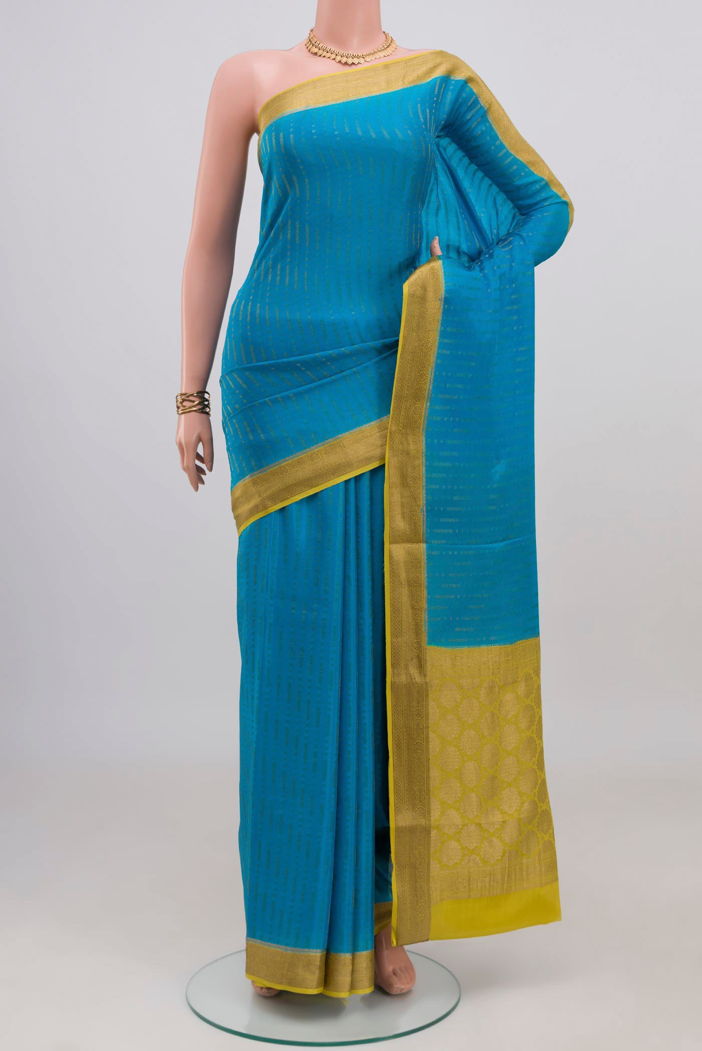 Blue Mysore Crepe Saree with Stripes on the body and Zari Border.  displayed on a mannequin
