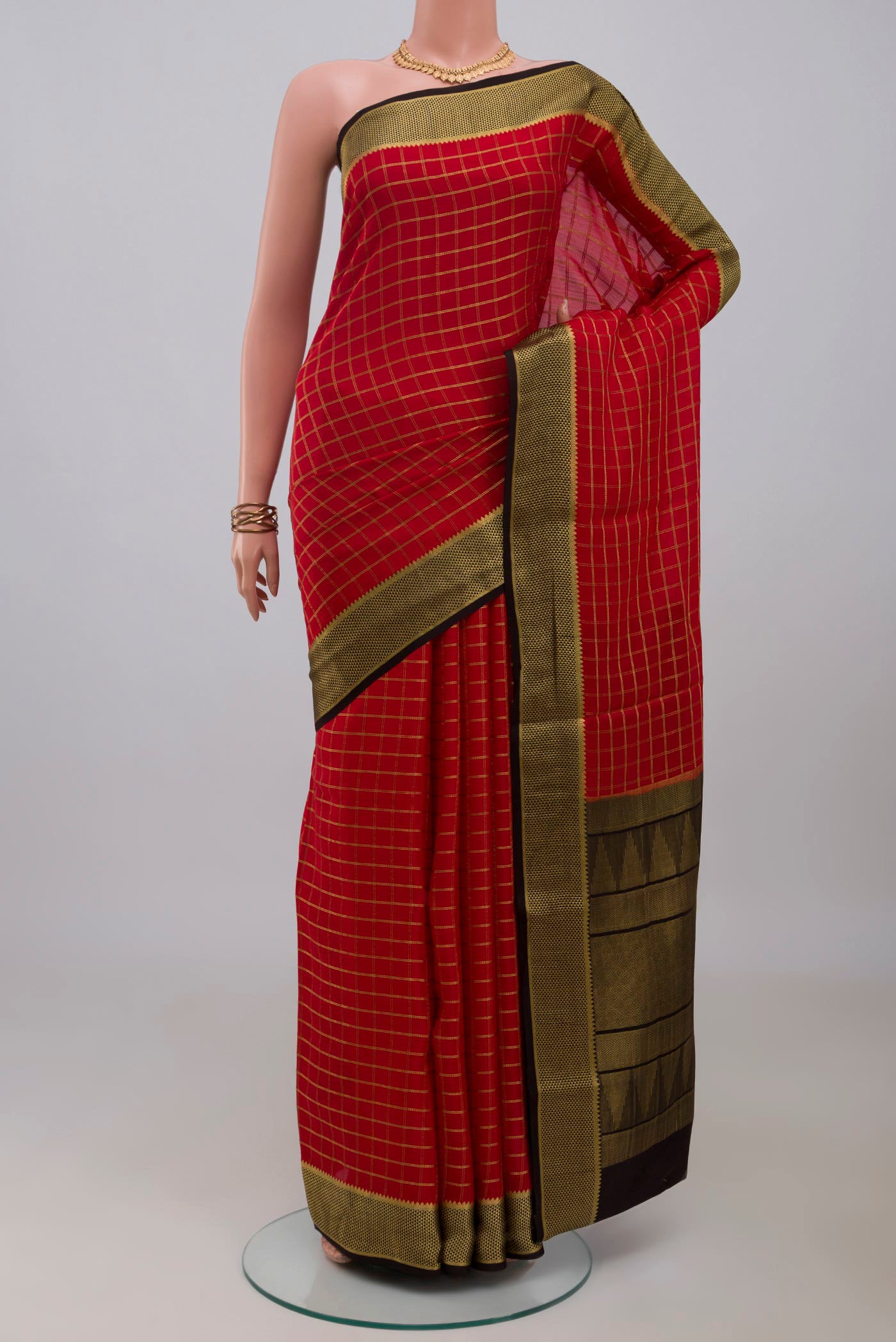 Red Mysore Crepe Saree with Checked design on the body and Zari Border.  displayed on a mannequin