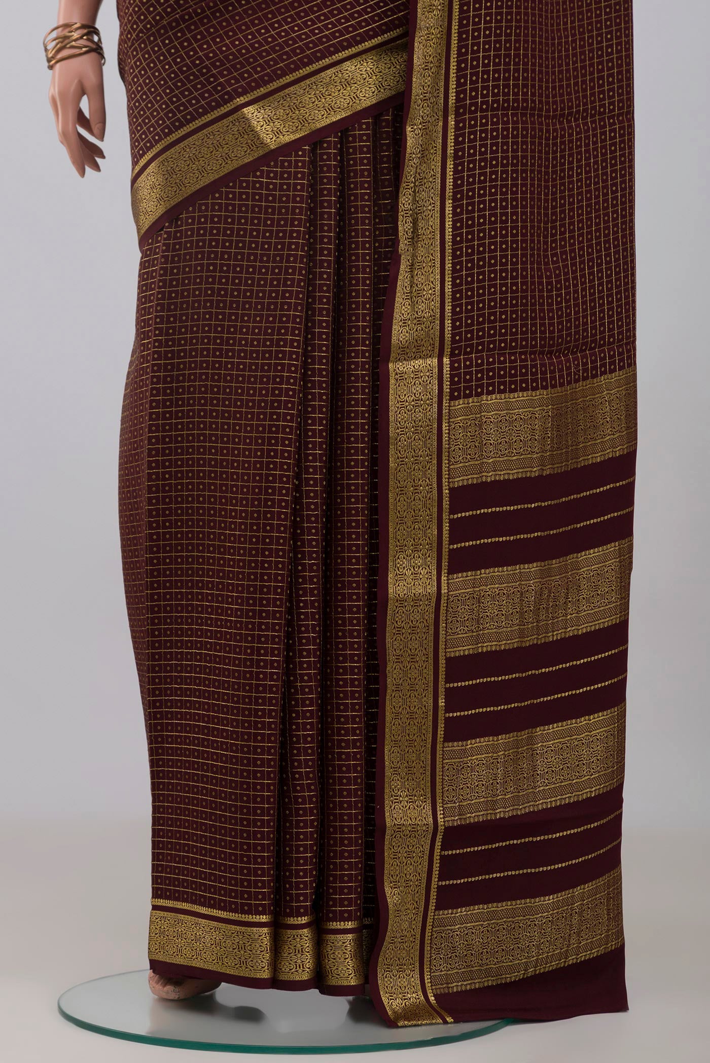 Pleats and pallu of Coffee Brown Mysore Crepe Saree with Checked design on the body and Zari Border. 